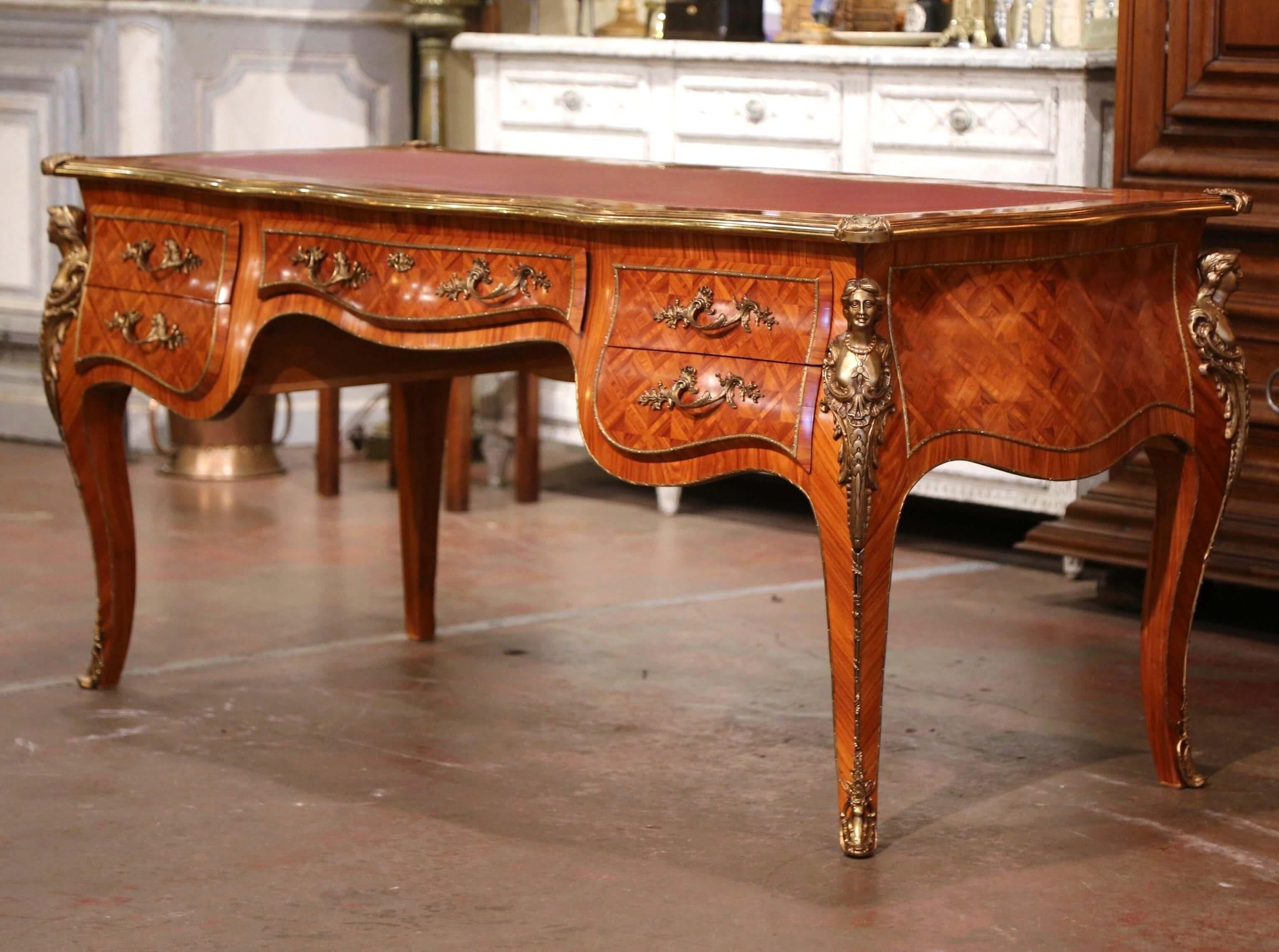 Created in Italy circa 2000 by Josephine Homes, this elegant antique desk stands on cabriole legs decorated with bronze figural ormulu mounts at the shoulders and ending with sabots over the feet. The writing table features five serpentine freeze