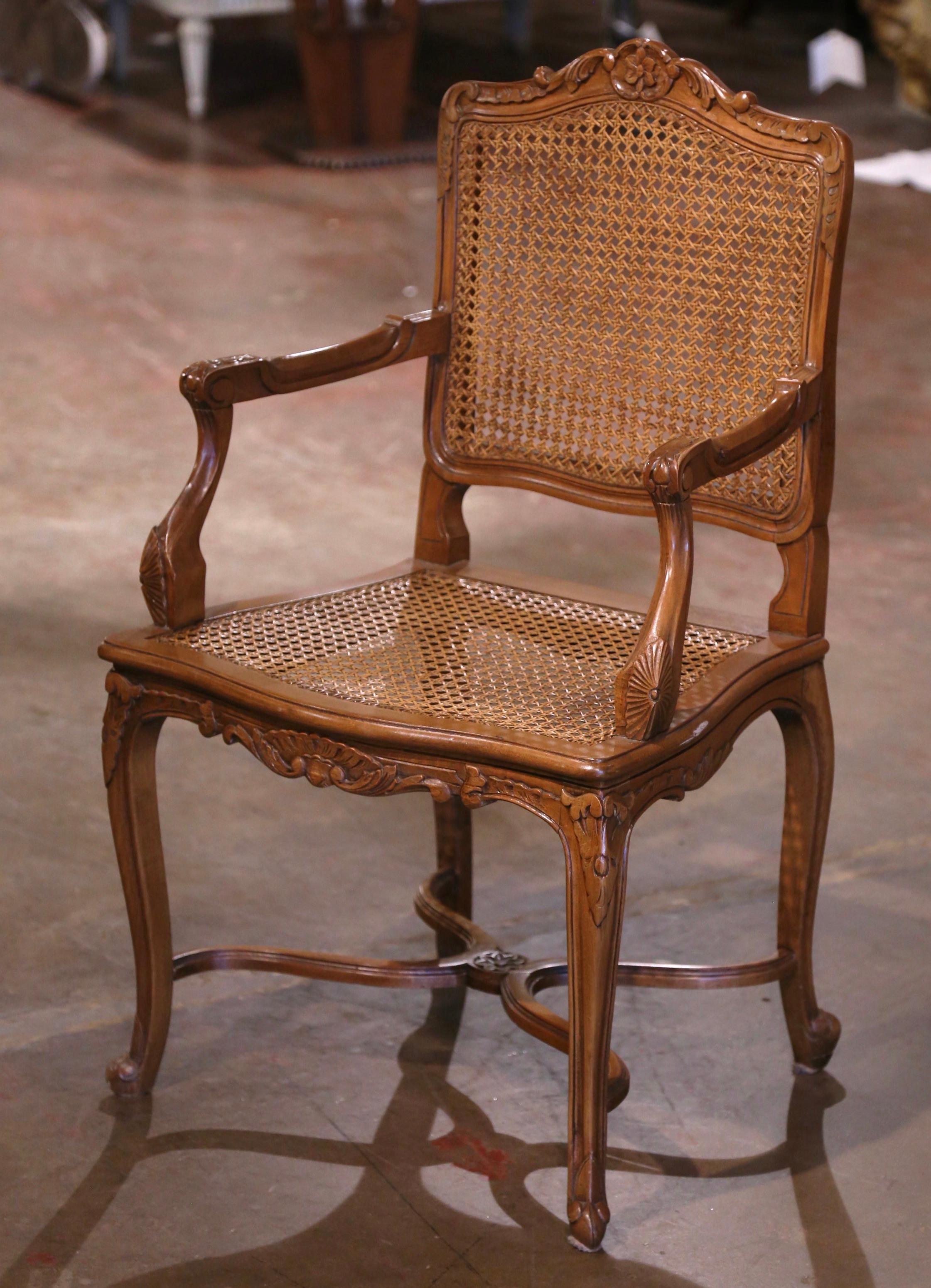 Decorate a study or office with this elegant vintage armchair. Crafted in Provence, France, circa 1990, the chair stands on cabriole legs decorated with leaf motifs at the shoulders, and ending with scroll feet over a decorative X stretcher. The