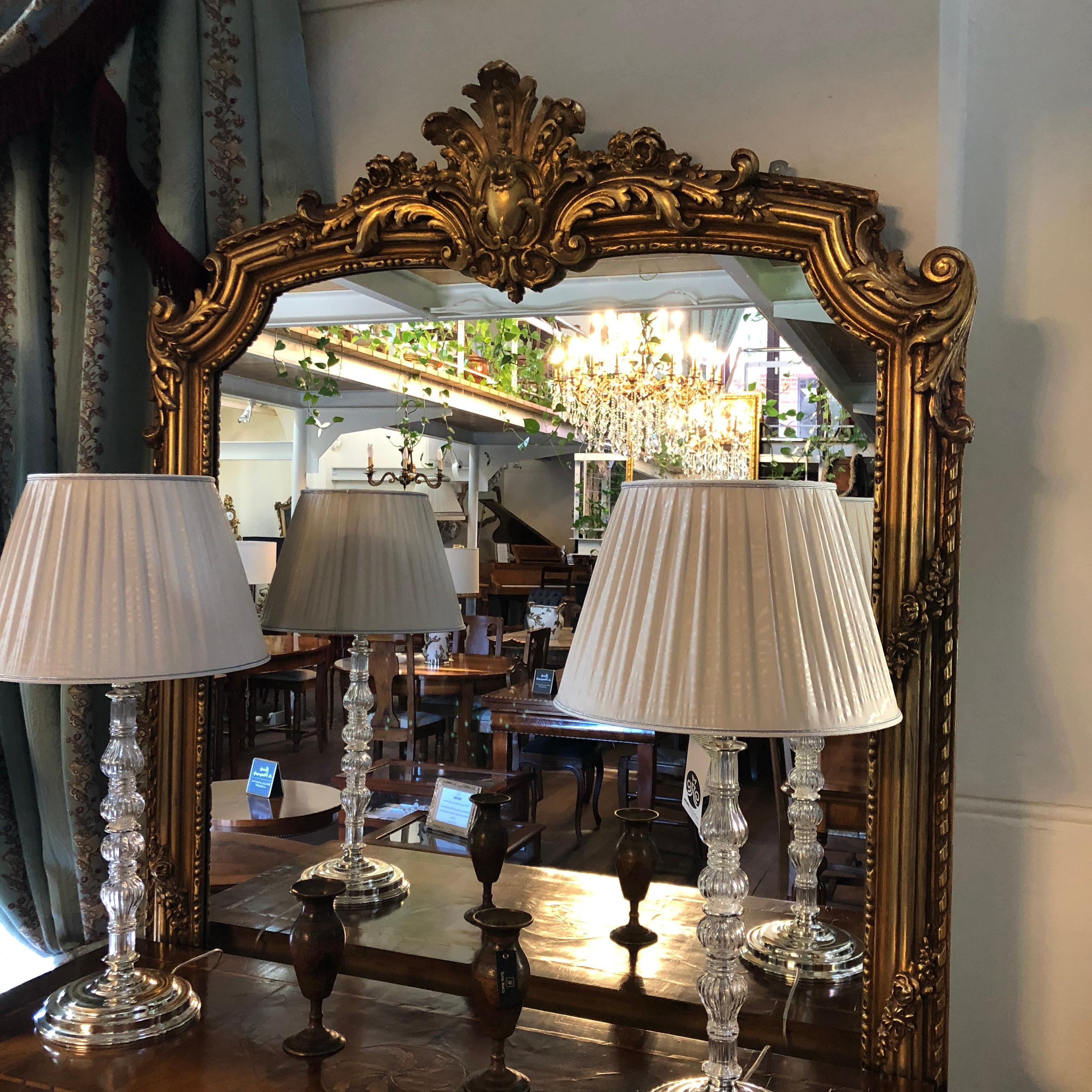 A grandiose mirror like this piece is extremely difficult to find and we are delighted to offer it for sale in our gallery. This magnificent 20th century, French Louis XV gilded wall mirror features the depiction of the Fleur De Lis at the top