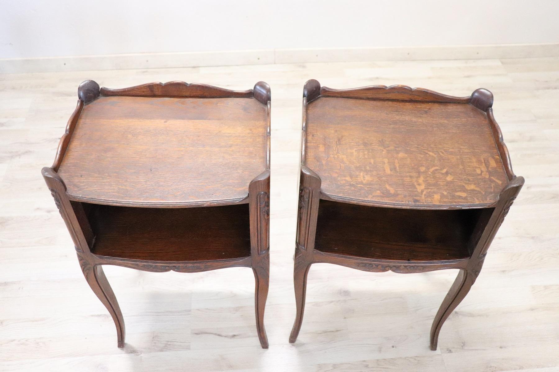 Beautiful pair of French Louis XV style bedside tables with slender legs and moves. Solid carved oak wood with floral decorations. A pair of really elegant bedside tables, ideal in the bedroom but also used in other rooms of the house. Used