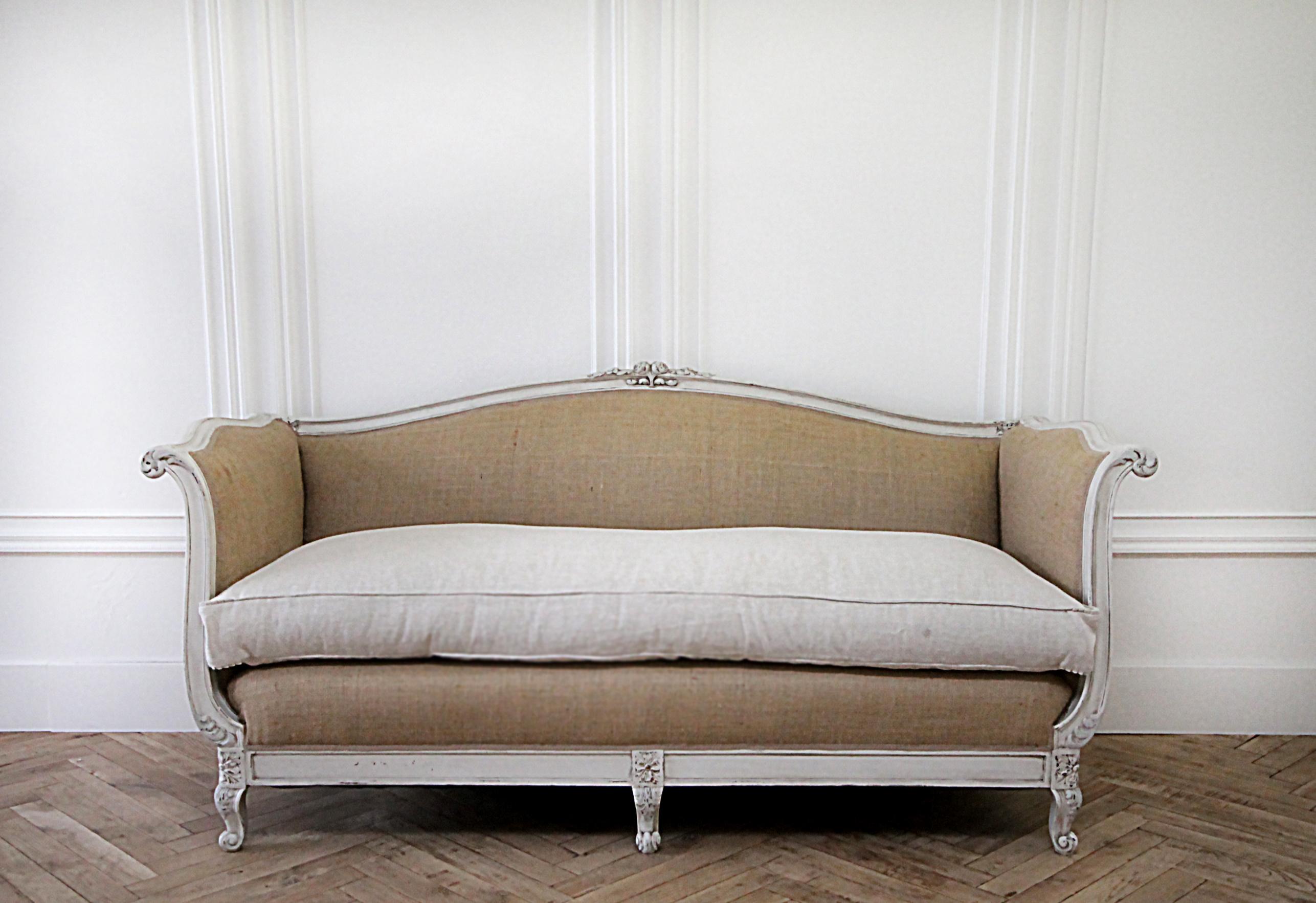 20th century French Louis XV Style linen upholstered sofa
A beautiful French style sofa upholstered in a burlap and 100% linen. The cushion is a thick nubby textured natural colored linen, finished with a flange and pleated ruffle corners. A plush