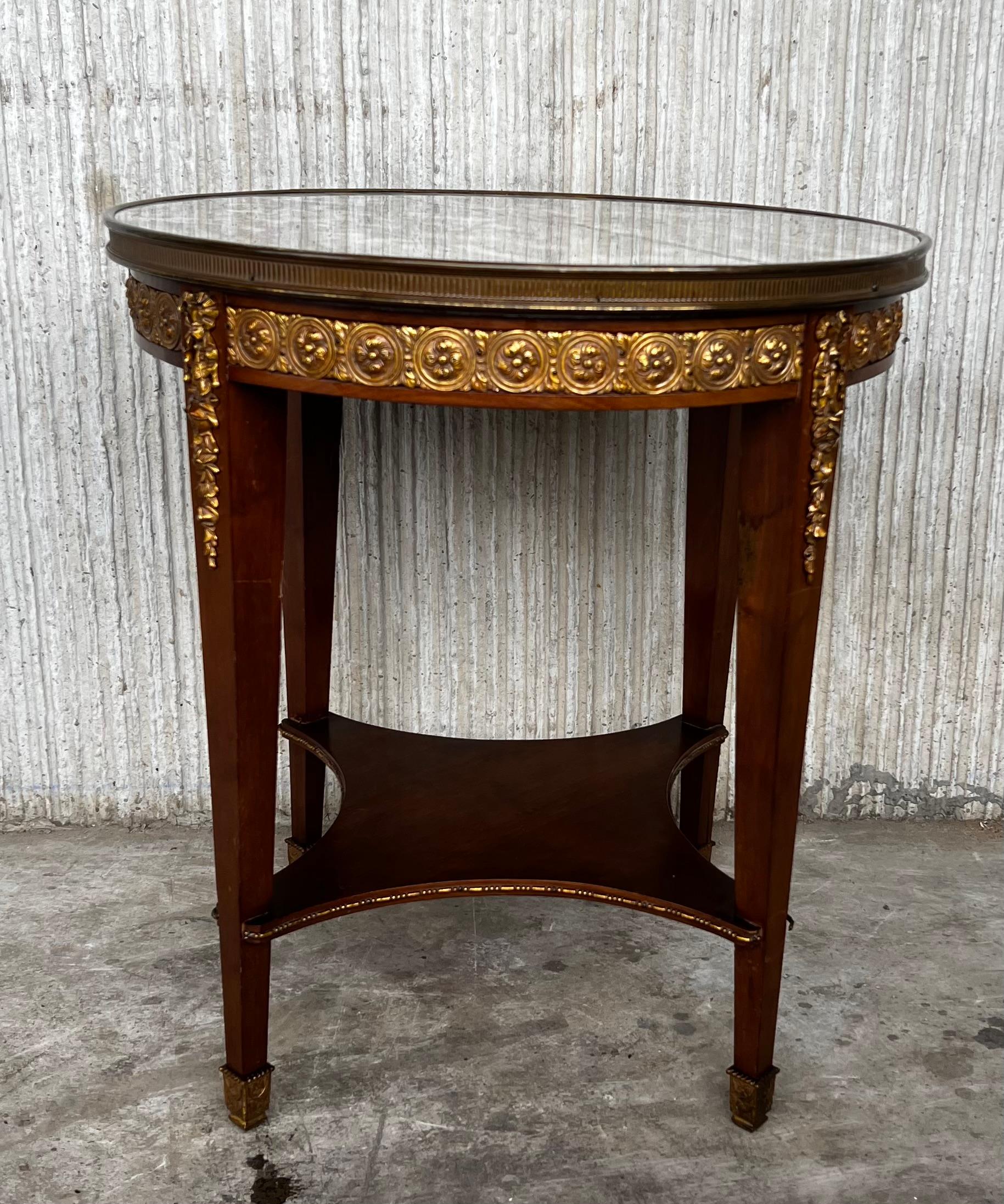 20th century Louis XVI style with bronze and round marble French oak wood table.

Solid oak with partial veneer and finely engraved bronze fixtures.