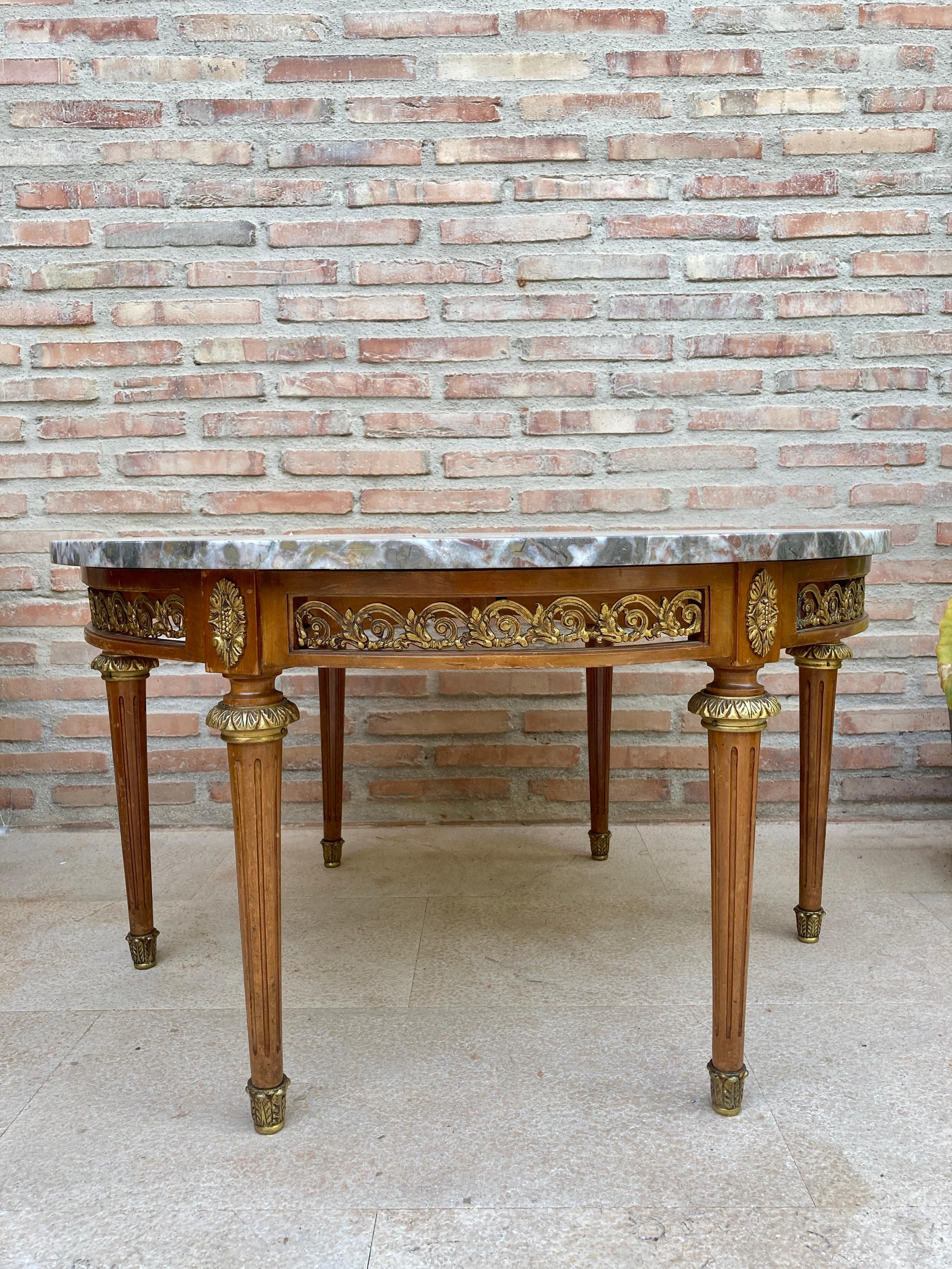 20th Century Louis XVI Style with Bronze and Round Marble French Oak Wood Table.

Solid oak with partial veneer and finely engraved bronze fixtures.