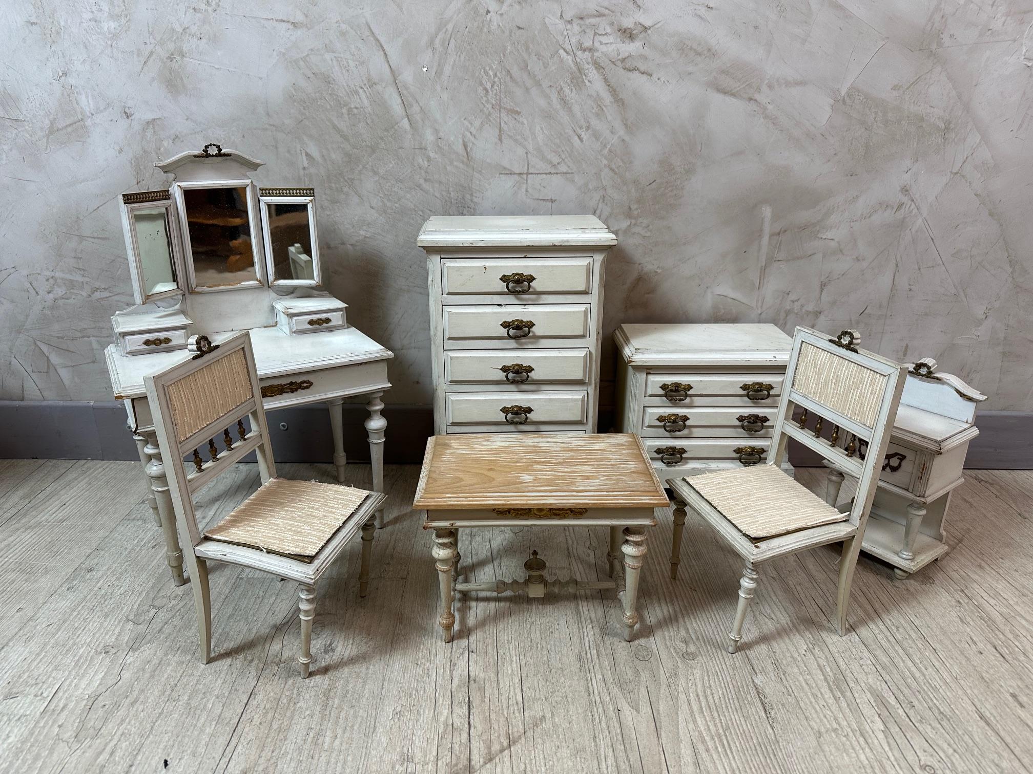 Beautiful set of Doll furniture made in the 1930s in the Louis XVI style. 
- A commode
- A dressing table
- Table with two chairs 
- A chests of drawers 
- A side table 
Nice quality. Stamp of the back of one piece. 