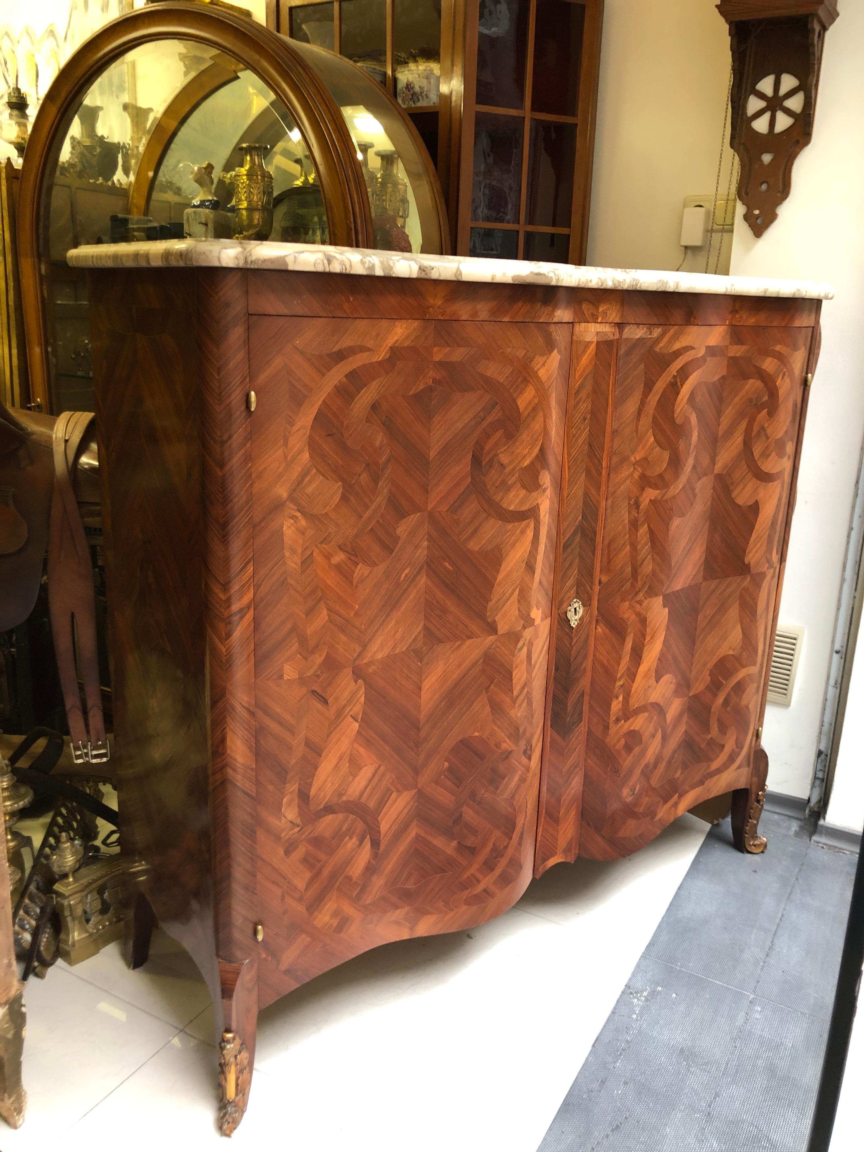 Rare as a decoration and shape this large serpentine commode made of fine quality mahogany will be a perfect accent in any style of home interior. The marble top is in very good condition and duplicates perfectly the shape of the doors. There are