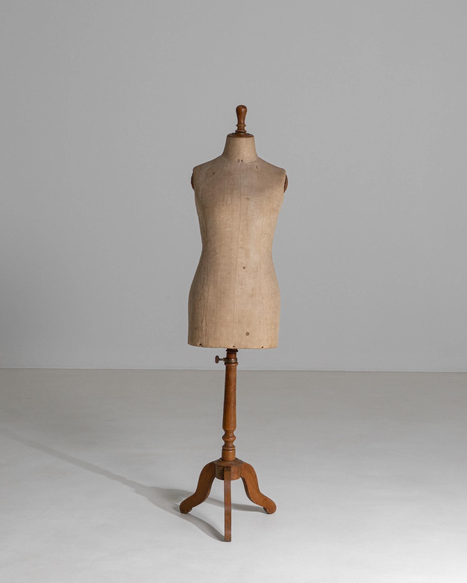 This elegant 20th century French mannequin captures the quiet beauty of utilitarian design elevated through time and use. The torso is formed in canvas-covered linen, softly contoured to reflect the human form, and displays subtle wear, markings,