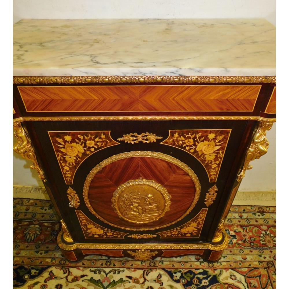 20th century French Marquetry inlaid marble-top cabinet with gold gilt cherub decoration and floral accents. Measures: 34