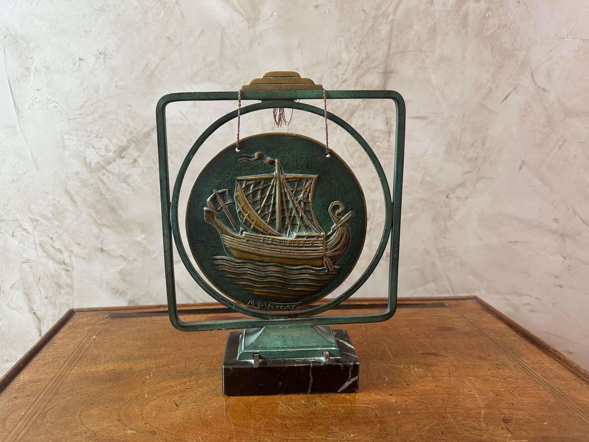 Art Deco bronze table gong signed by Max le Verrier on a marble base, representing a sailboat. Missing the hammer.
Green patina.
Beautiful quality and rare object.