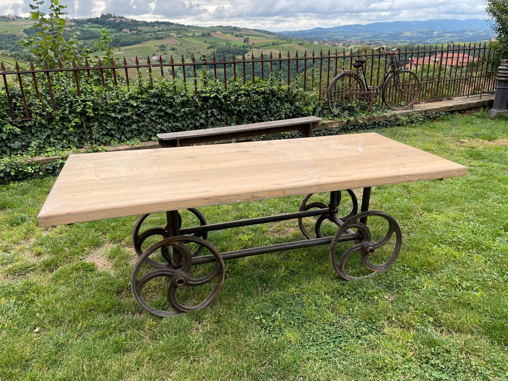 Very nice and original 20th century French dining table made from a industrial machine. 
The top is a thickened raw wood and its removable from the base. 
The table is rolling. It can be easily changed as a coffee table in reducing the metal