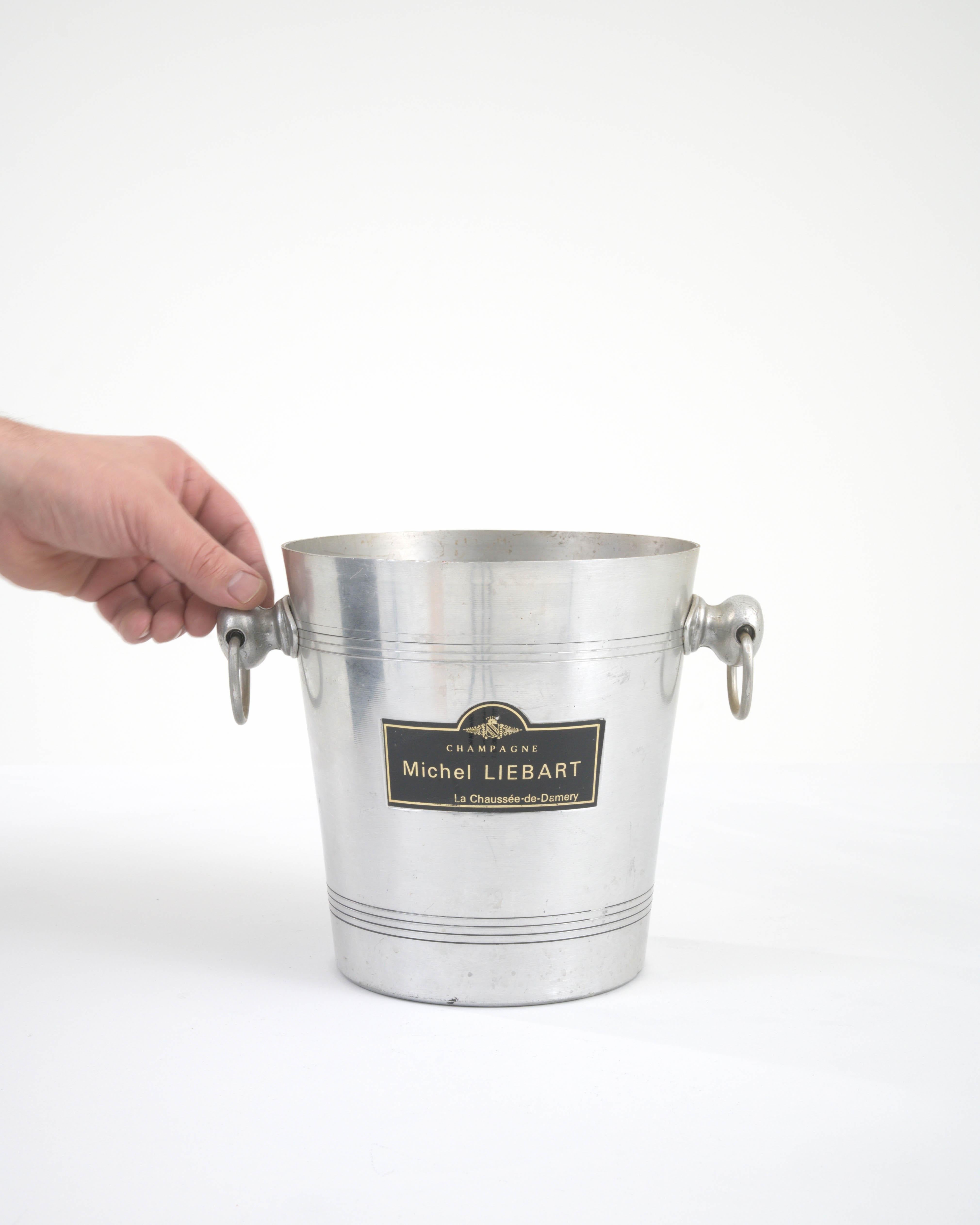 Elevate your hosting game with this authentic 20th Century French Metal Ice Bucket, a testament to timeless elegance and utility. Crafted with the finesse of a bygone era, its sleek silver finish and sturdy metal construction promise durability and