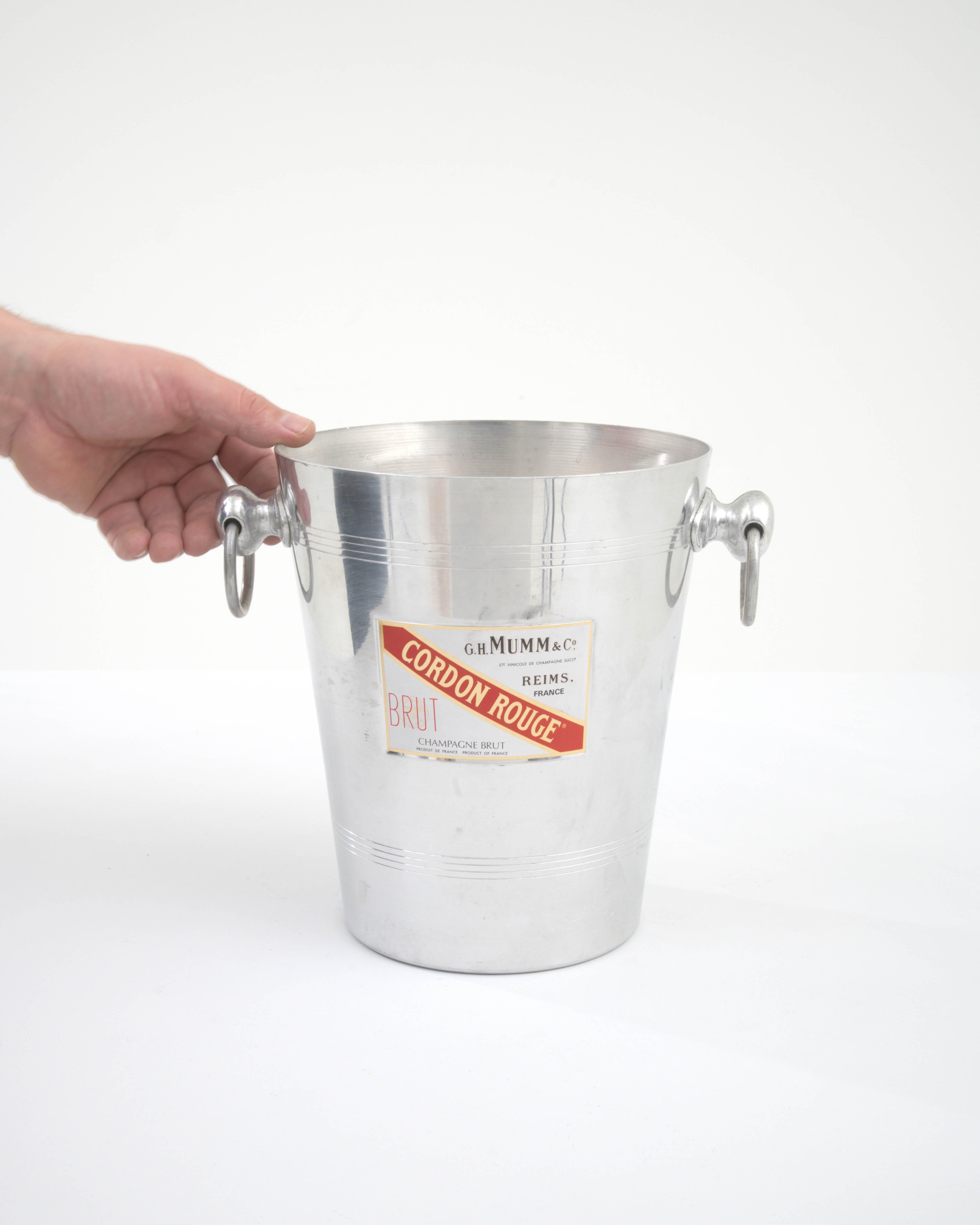 Presenting the 20th Century French Metal Ice Bucket, a piece imbued with the spirit of celebration and sophistication. As you entertain, let the iconic G.H. MUMM & Cie label - synonymous with exceptional champagne - be your partner in setting a