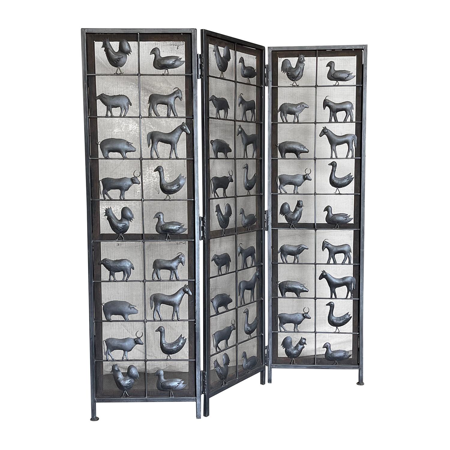A vintage Mid-Century modern French room diver made of hand crafted wrought iron designed by Jean Touret and produced by Atelier de Marolles, in good condition. The detailed Brutalist style screen is composed with three adjustable panels, each of