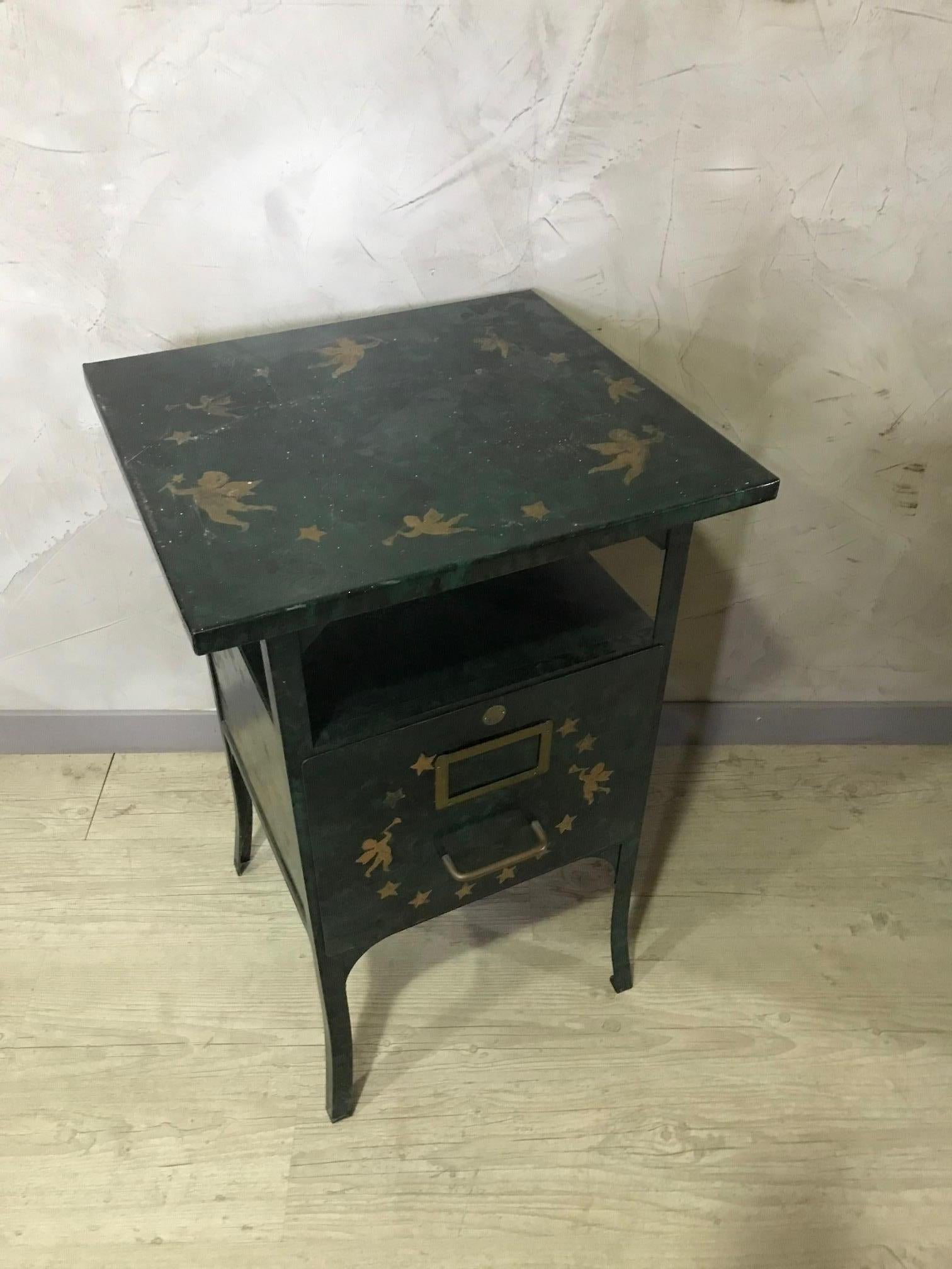 Original 20th century French green metal rolling storage cabinet from the 1920s.
Used to help nurse in Hospital.
Four wheels. Green metal and drawing golden angels and stars.
Stamp of the French Manufacturer in Paris.
Large opening drawer.
Good