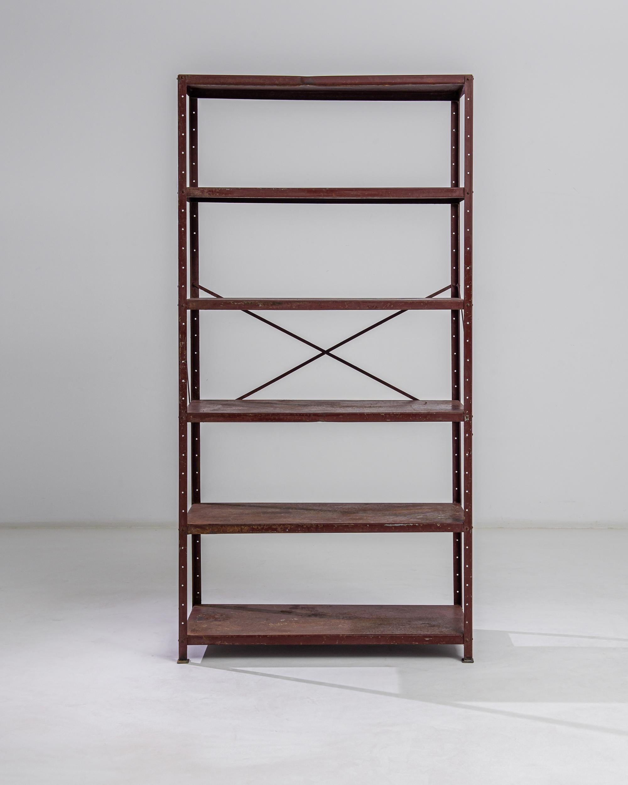 Capture the essence of industrial chic with this 20th Century French Metal Shelving Unit. Boasting a robust iron construction, its sturdy frame and five generous shelves offer both durability and ample storage space. The rich patina of the metal,