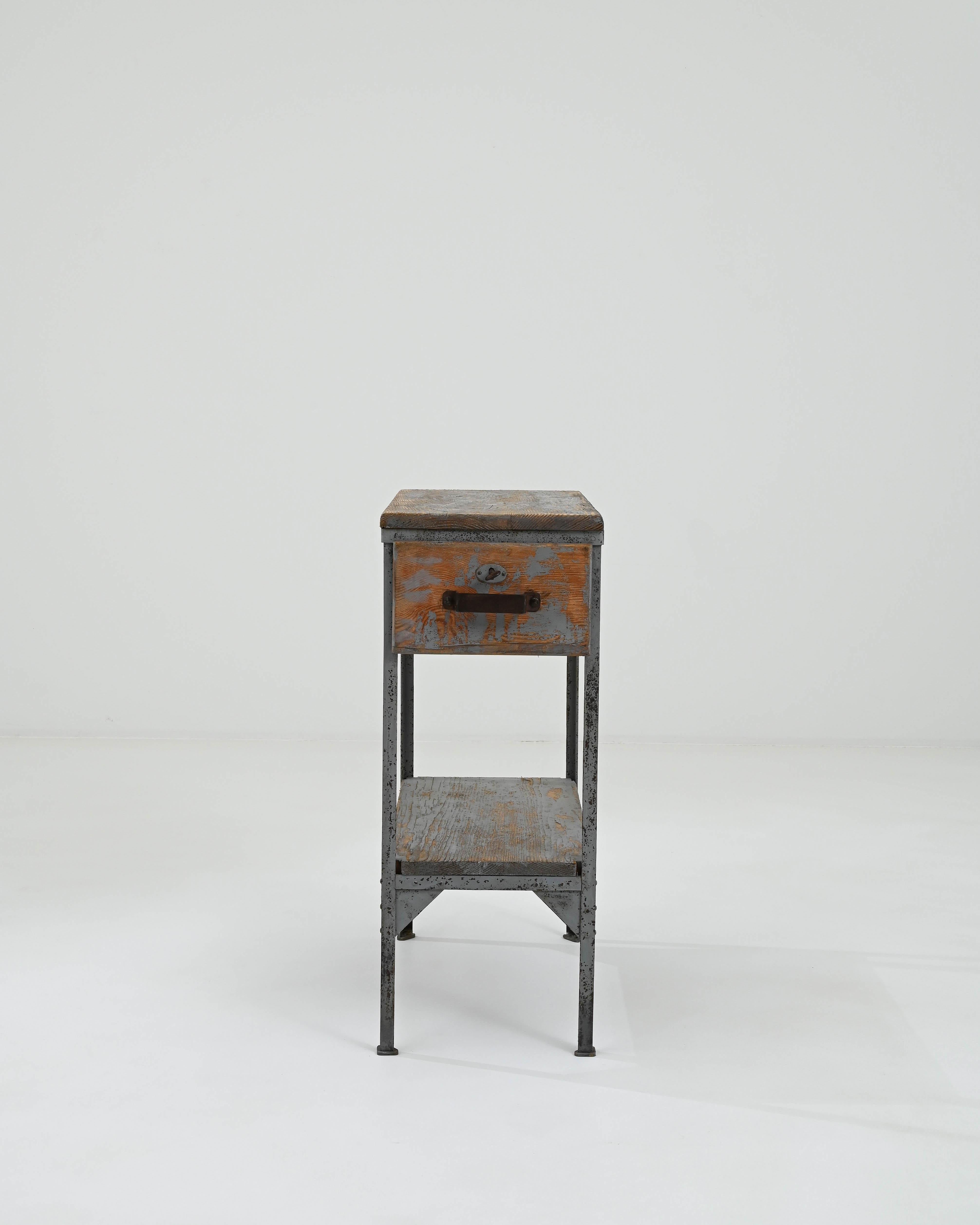 Introducing a quintessence of rustic charm and industrial flair, this 20th Century French Metal & Wood Work Table is a storied piece that promises to elevate your home with its vintage allure. Crafted with the robustness of metal and the warmth of