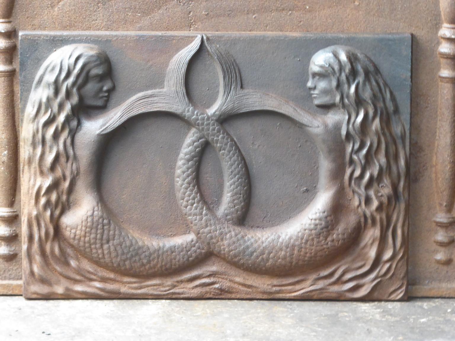 20th century French modernist fireback with two mermaids. 

The fireback is made of cast iron and has a natural brown patina. Upon request it can be made black. It is in a good condition, without cracks.