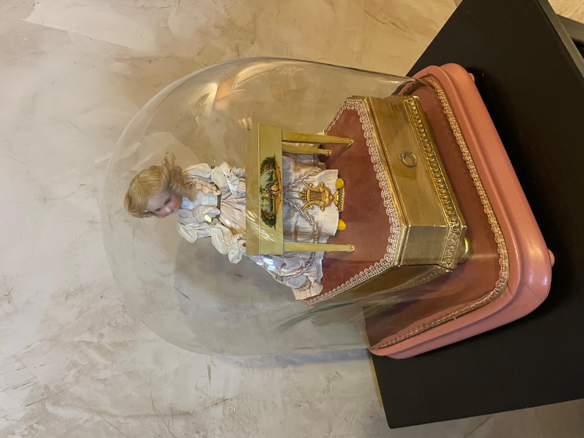 Magnificent and rare automaton pianist doll under a globe made by automaton repairer and manufacturer Jean Farkas in the 1950s. 
The doll plays a serenade of Haydens by Mozart, its arms and head are articulated and move to the rhythm of the music.