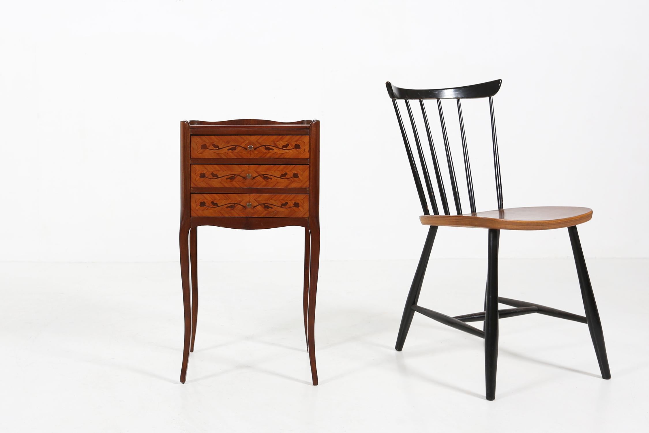 France / 1950 / chest of drawers / wood / Napoleon III / Romantic / Antique

Napoleon III style cabinet or nightstand in wood with delicate abstract floral marquetry inlay. This elegant small chest of drawers rest on four elegant curved legs and has