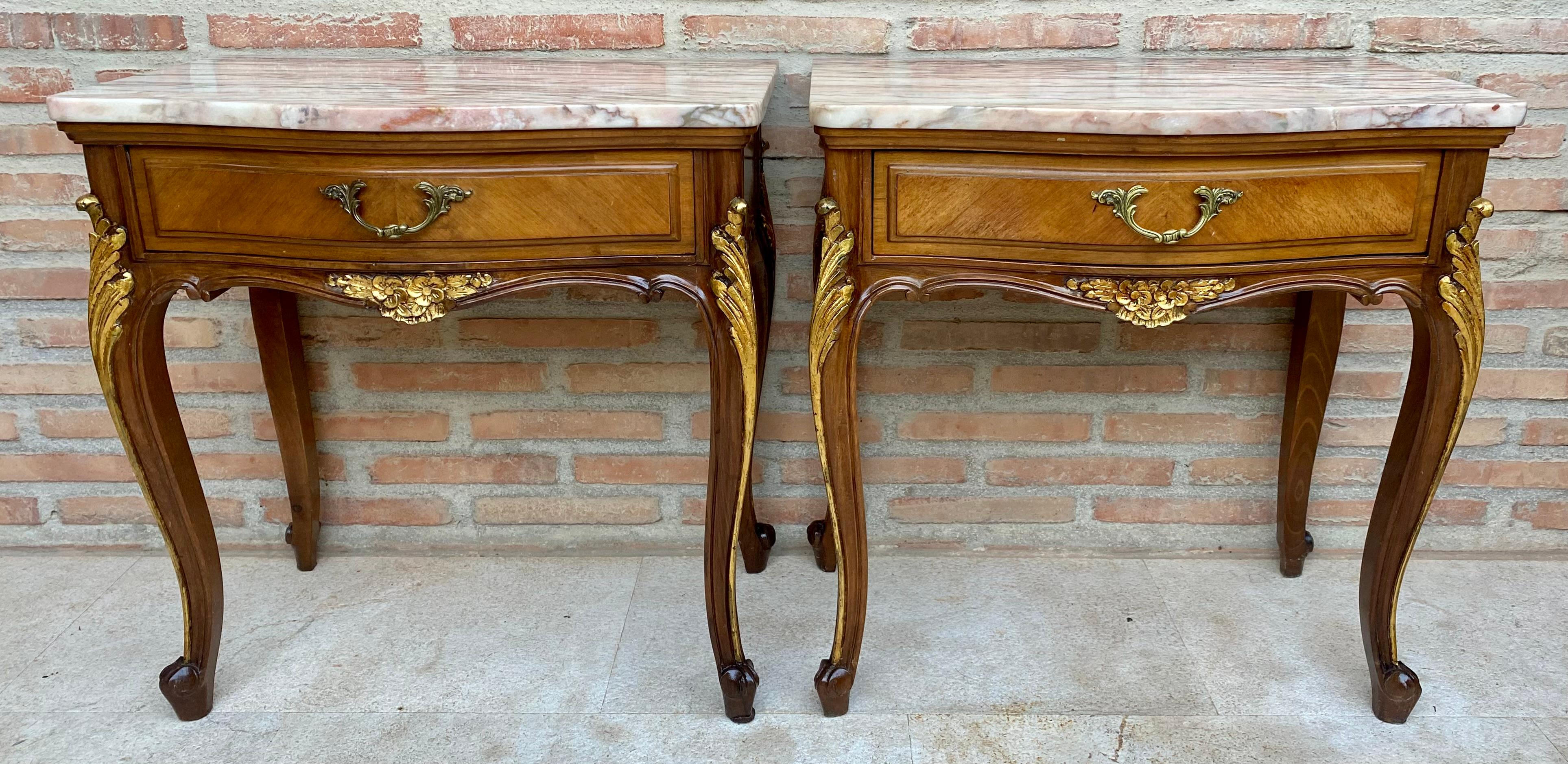 Pair of early 20th century French bedside tables with beautiful marble top, a drawer with a bronze handle and cabriole legs. The tables have a beautiful carving on the legs and skirt on the front with very beautiful golden skates.