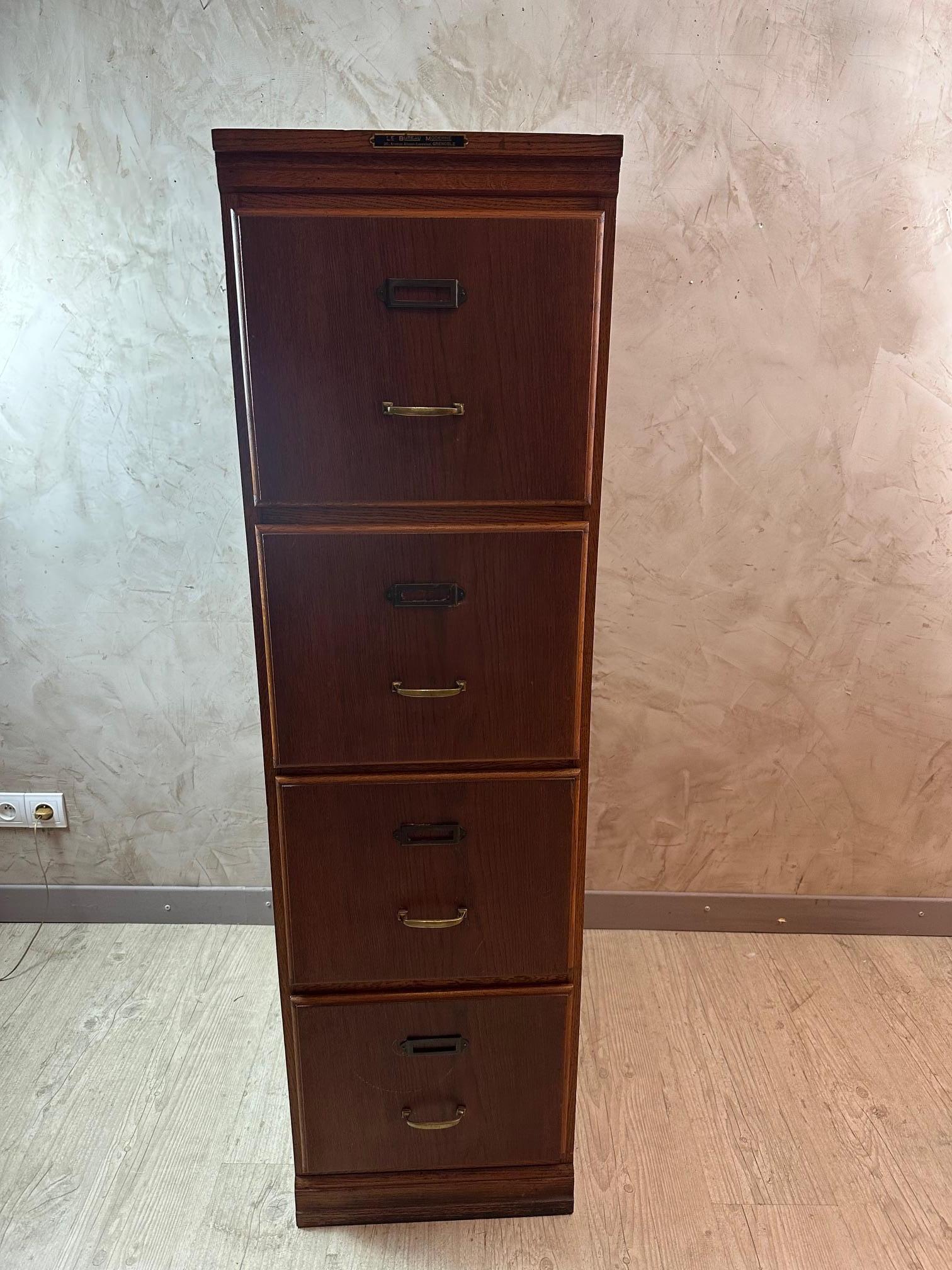 Oak office file cabinet with four drawers dating from the 1920s in very good condition. Was used for storing files in an office in Grenoble France (stamp proving it). Brass handles and metal label holders. Good quality. Ideal in an office.
