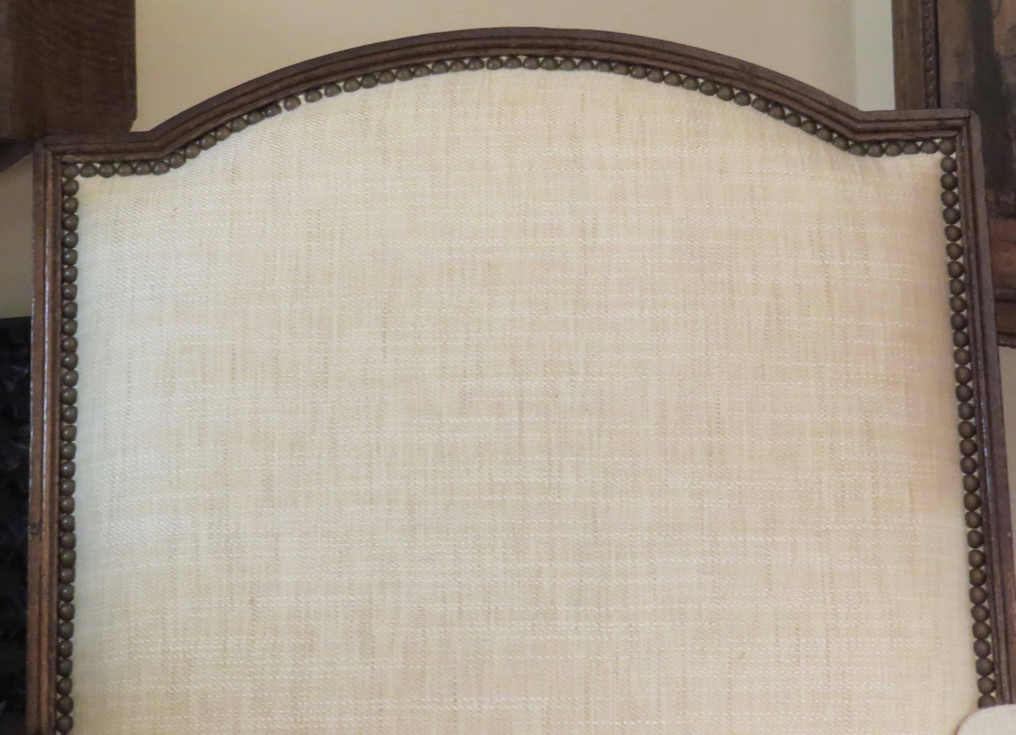 Stained 20th Century French Oak Bergère Upholstered in Ivory Linen For Sale