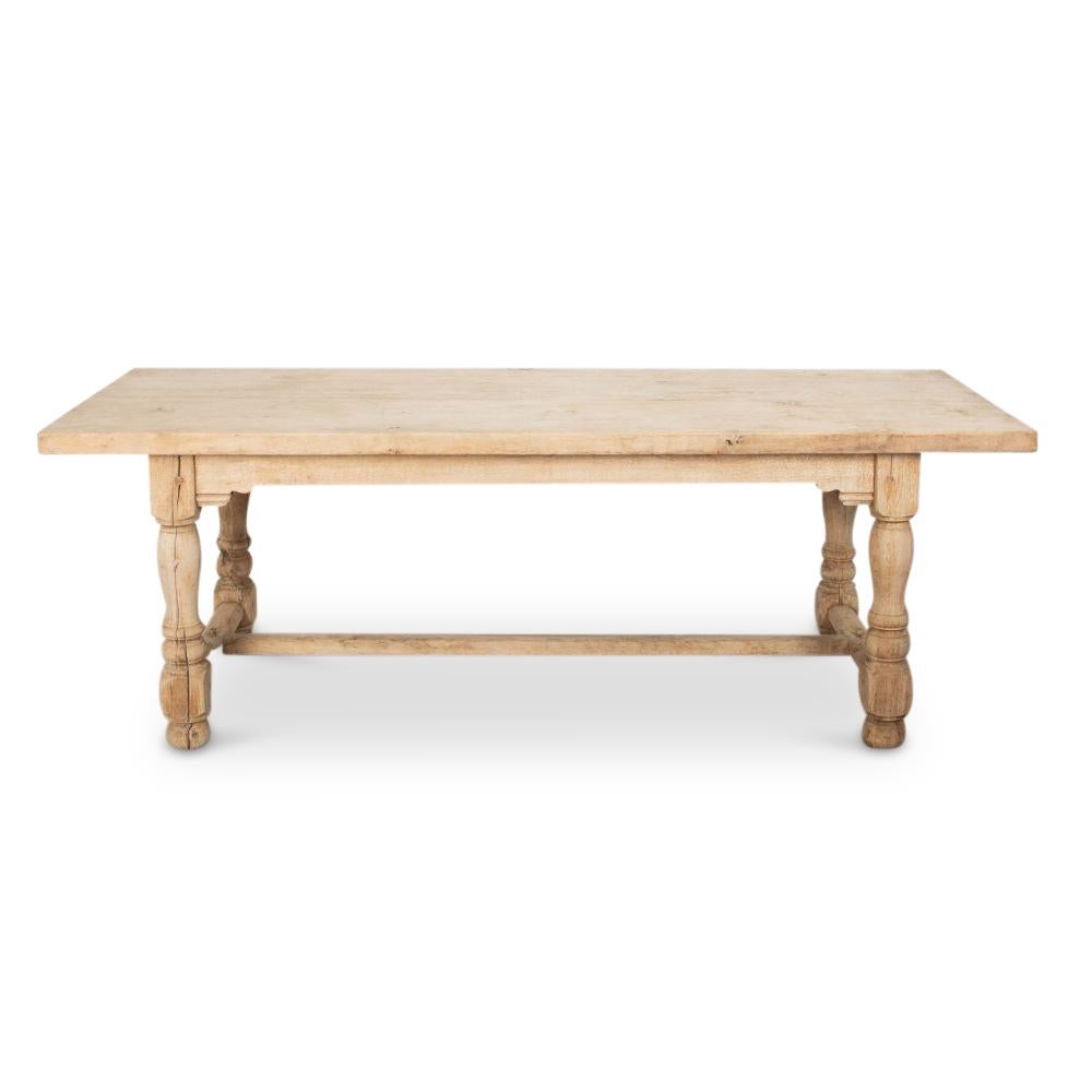 Beautiful 20th Century bleached oak farmhouse table. 

With super bolstered legs and a decorative freeze support a substantial plank top.
