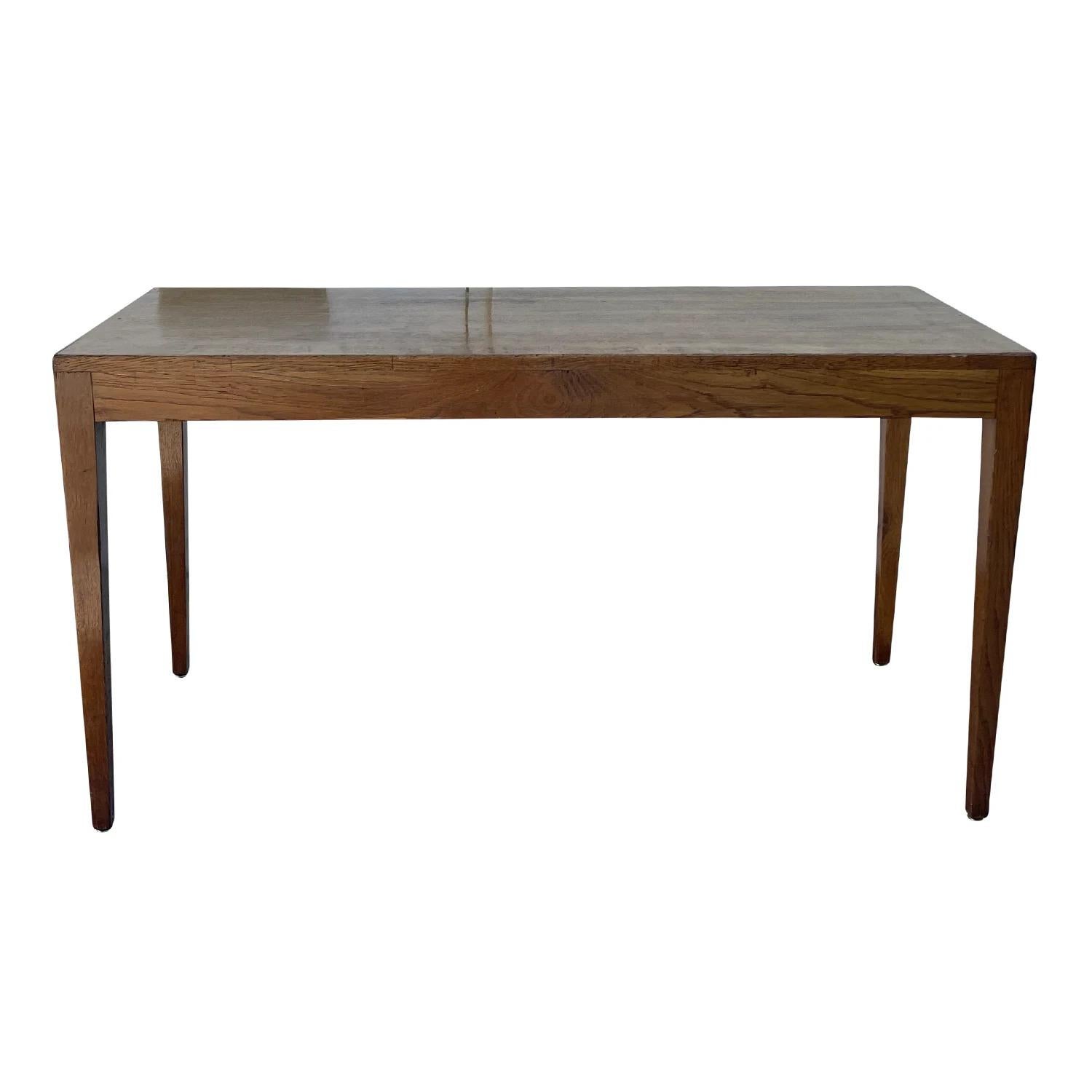 A light-brow, vintage French Art Deco freestanding console table made of hand crafted polished Oakwood, designed most likely by Jean-Michel Frank in good condition. The rectangular side, end table is standing on four long square legs. Wear