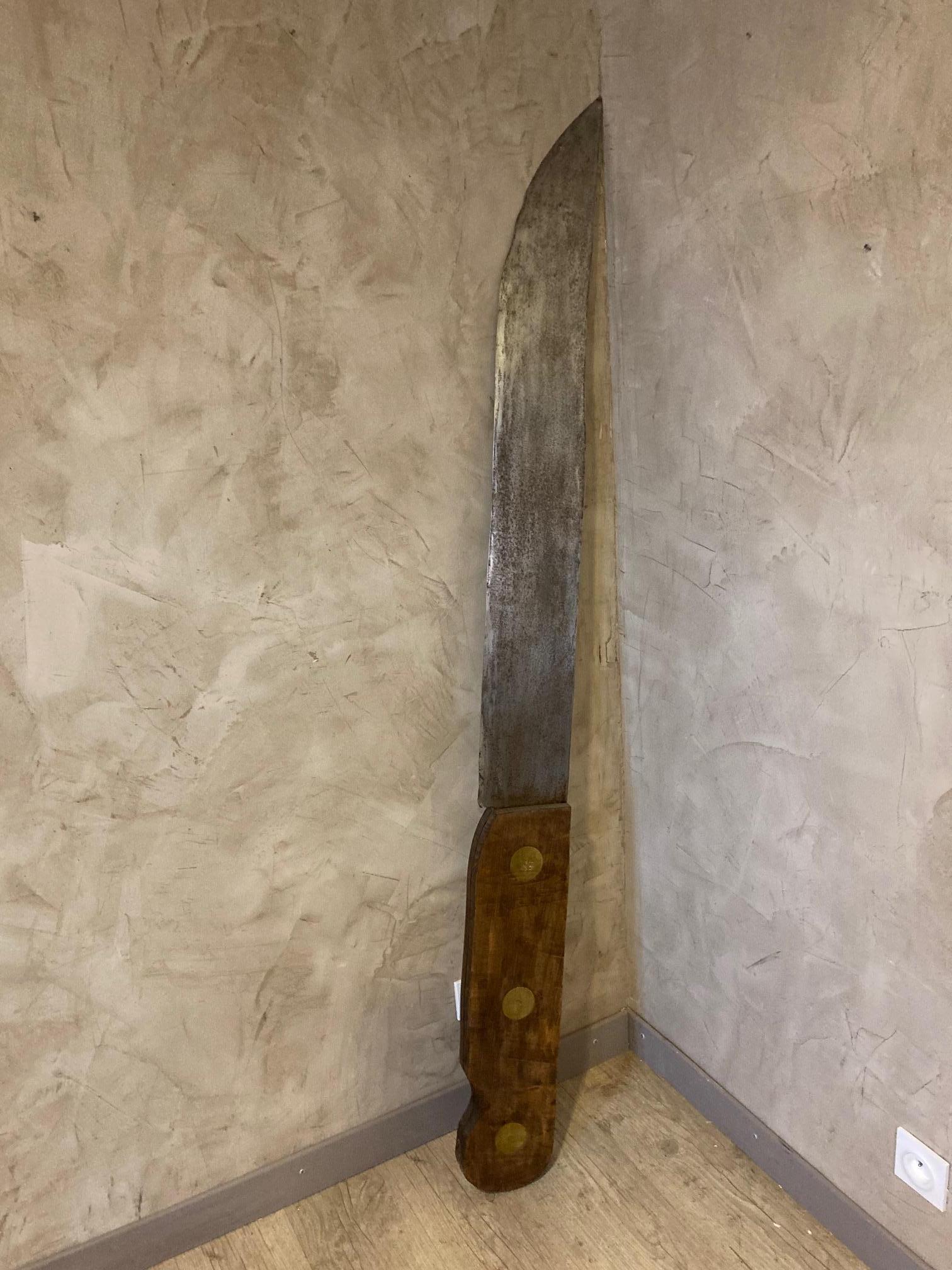 Very rare and original 20th century large metal and wood knife maybe an old cutler signboard. 
The blade is made with metal and the handle is made with wood. Brass nails. 
Good condition and quality.