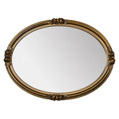 20th Century French Oval Giltwood and Stucco Mirror with Floral Decoration