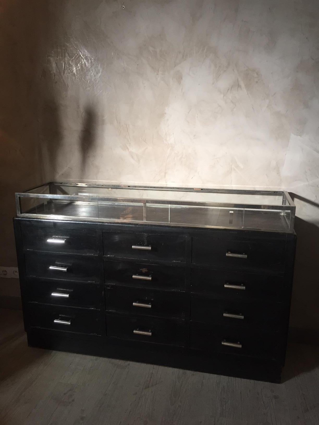 Very nice 20th century French painted Aberdashery vitrine and Chest of drawers from the 1920s. Very nice Black patina. 
Maybe a gloves cabinet. The drawers are 