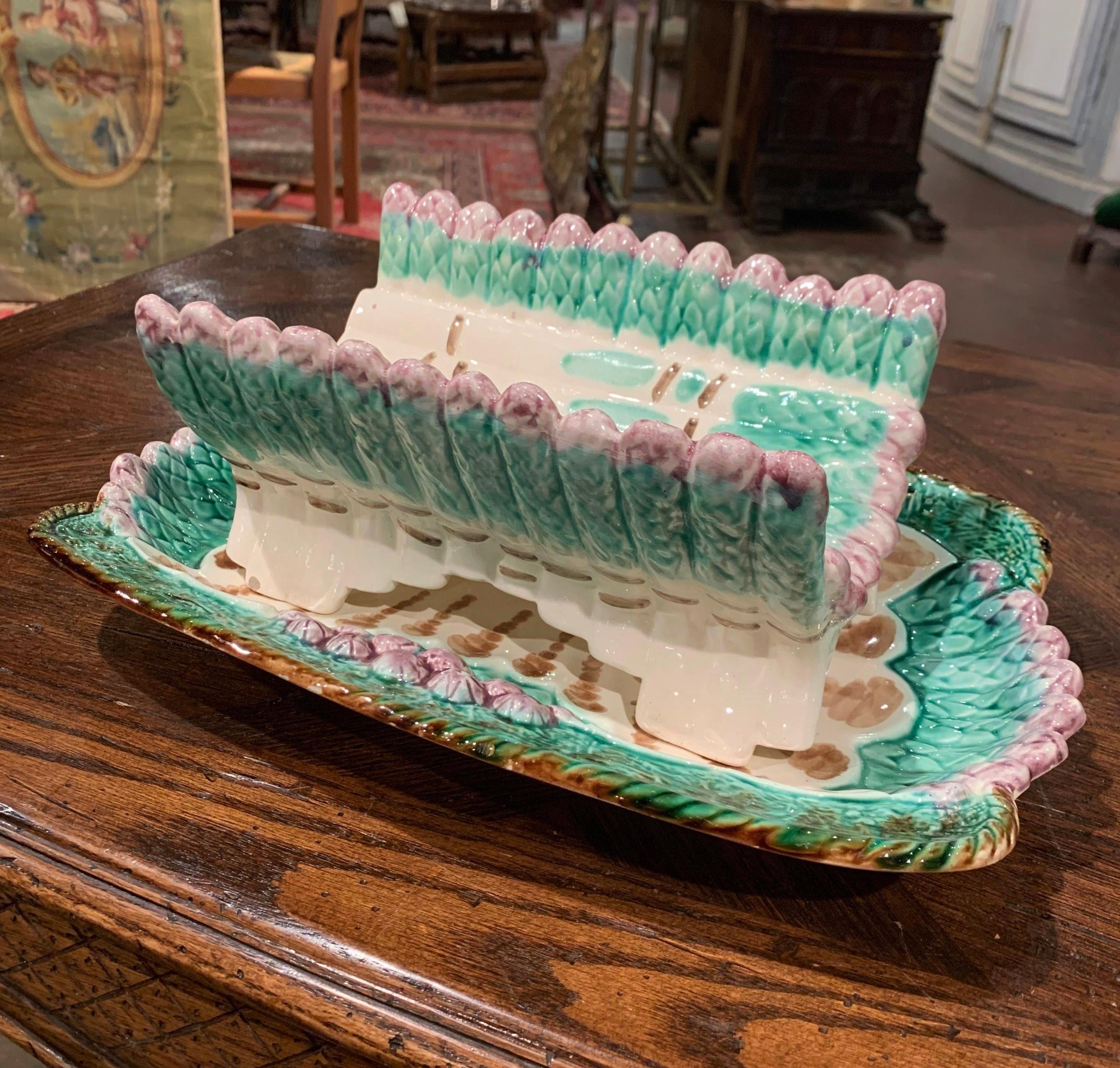 Dress up your dining room table or kitchen counter with this fine colorful hand painted Majolica asparagus dish. Sculpted in Longchamp, France, circa 1940, the platter with side handles features a cradle dish shaped as asparagus sited on a scalloped