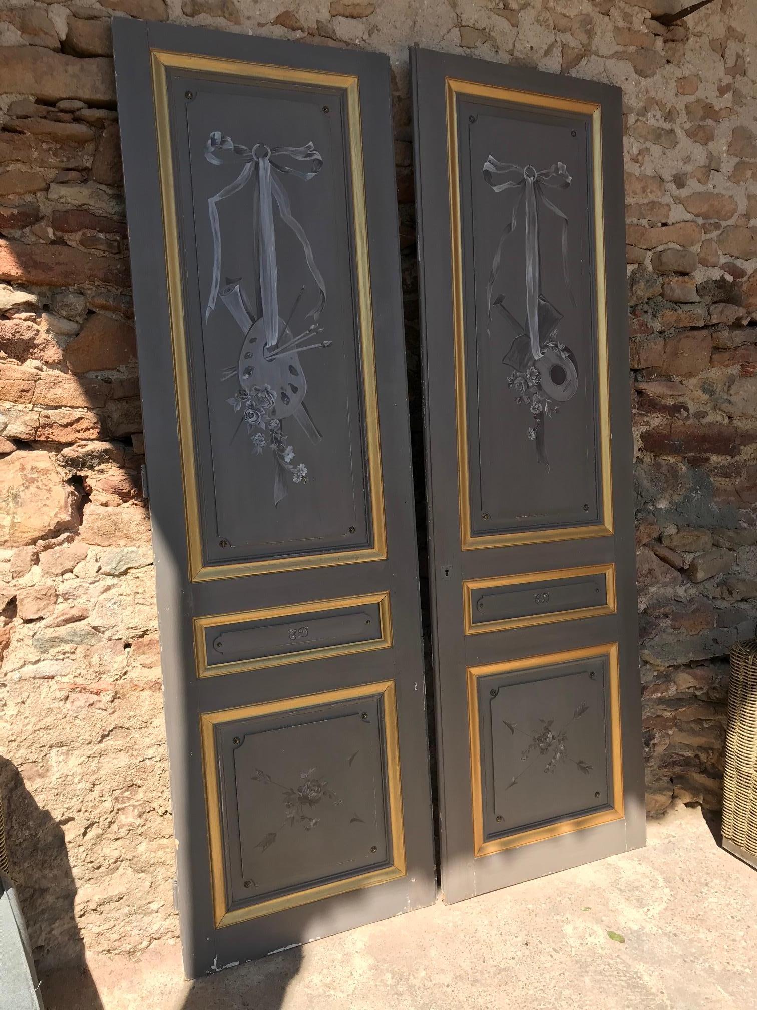 Beautiful 20th century French painted double doors from the 1900s. 
Unique and handmade painted work representing a paint palette and a mandoline.
Can be used as a cupboard doors or communication doors. 
Has been painted by a French amateur