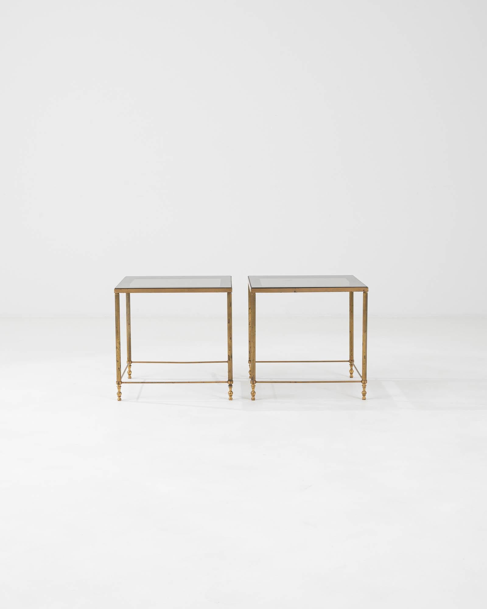 Elevate your living space with the sheer opulence of these 20th Century French Brass Coffee Tables from the renowned Maison Jansen. These twin tables exude luxury with their lustrous brass frames, each accented with delicate finials and a sleek