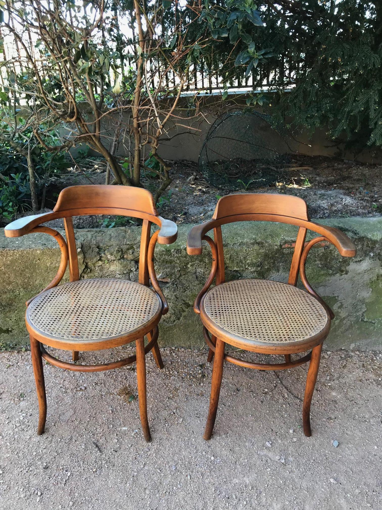 Very nice 20th century French pair of caned desk armchairs from the 1900s. 
Fake pair because one is a little bit smaller than the other and the tallest has a maker stamp. The stamp is from a French furniture maker P&R.PROIX 84 rue Blanche IXème -