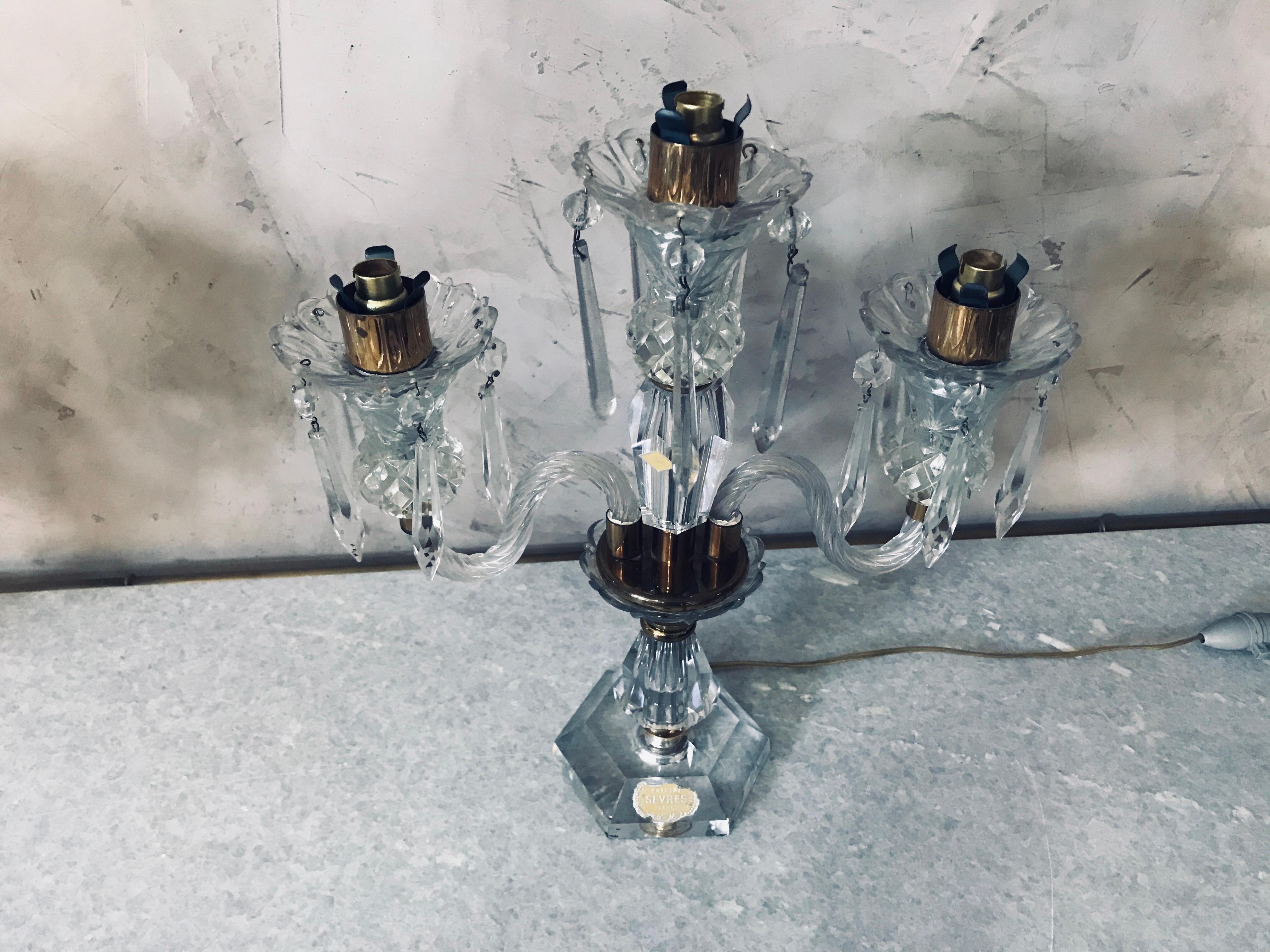 Schönes Paar französischer Sèvres-Kandelaber aus Kristall und Messing aus den 1950er Jahren.
Hergestellt in Frankreich von der berühmten Cristallerie House Sèvres. 
Dieses Kandelaberpaar steht unter Strom und hat jeweils drei Lichter. 
Stempel