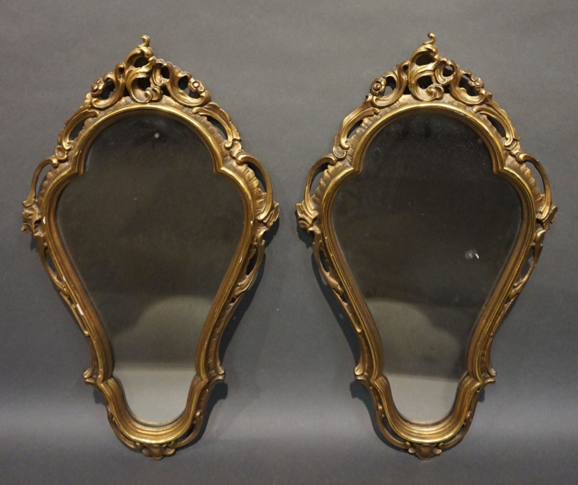 French hand carved and gilt wood pair of wall mirrors with lovely symmetrical frames and original glass.
France, circa 1930.