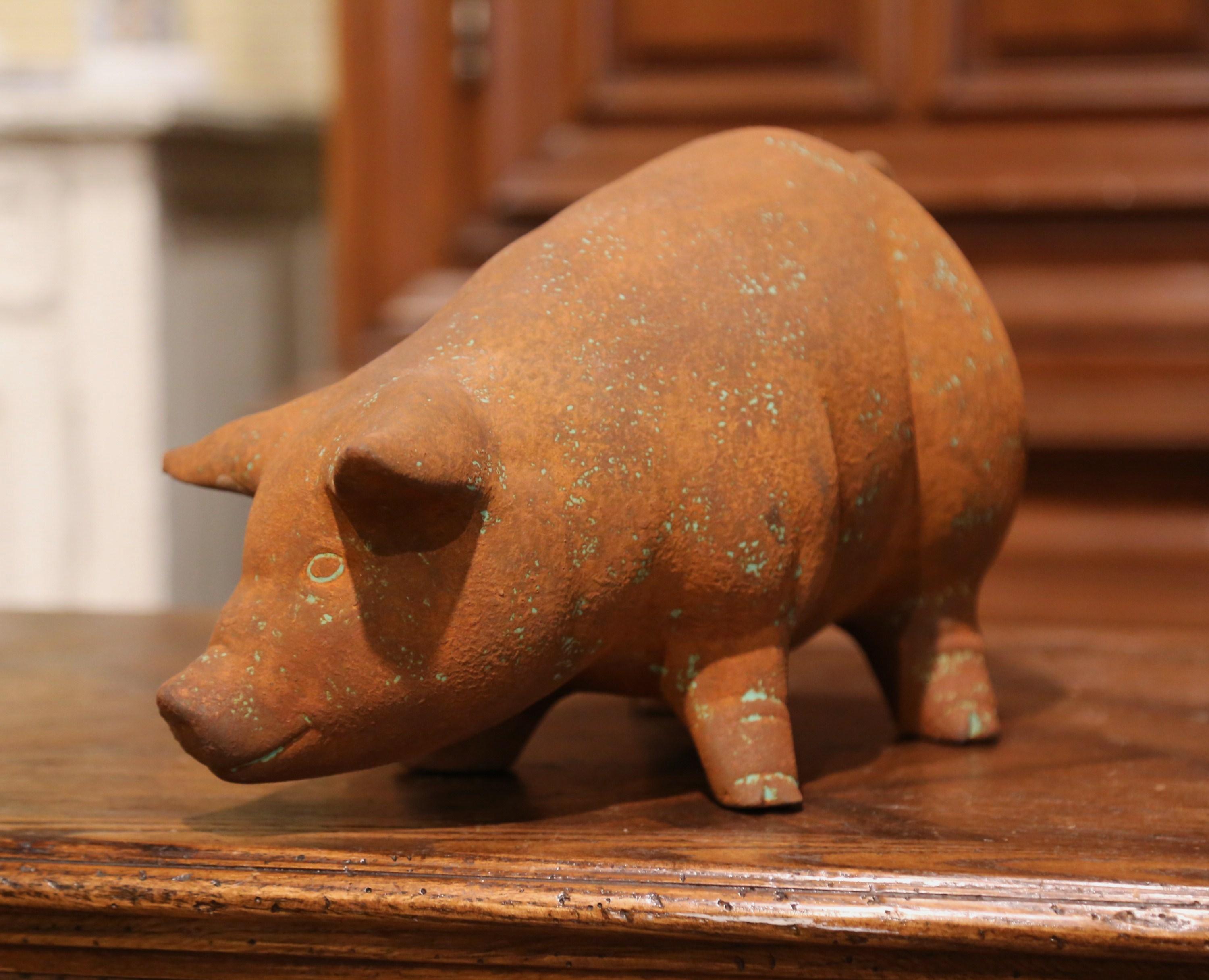 Decorate a kitchen counter or a patio with this cheerful pig sculpture. Crafted in France circa 2000, the earthenware figure depicts a fat hog standing and sniffing. The vintage pig is in excellent condition and adorns a nice patinated texture