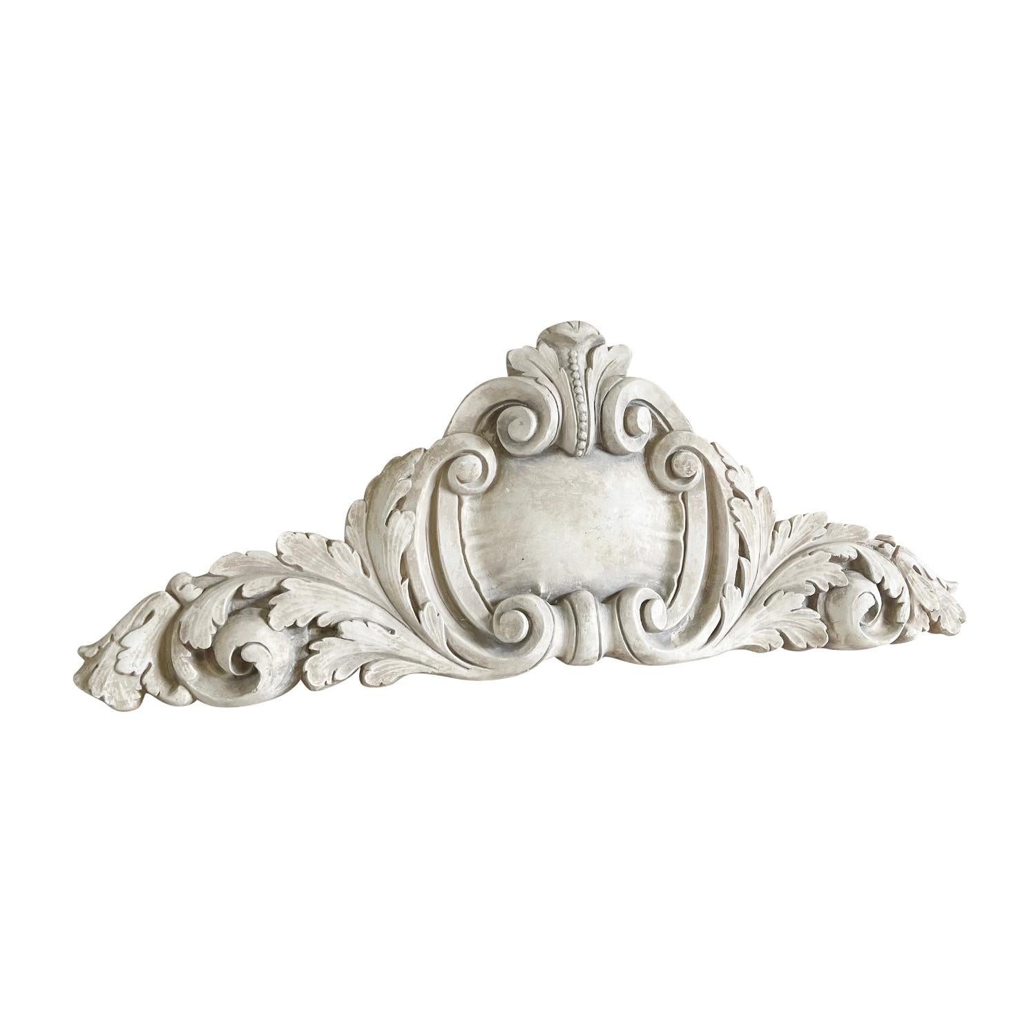 An oversized vintage sopra porte in the shape of an architectural element decorated with acanthus leaves and scrolls. The architectural model is molded in French Plaster. This material was often used for the interior of buildings. The decoration was