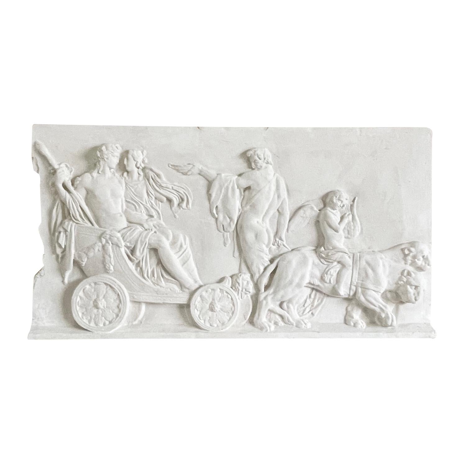 A vintage French wall relief in plaster depicting the Greek God Dionysus and the Greek princess Ariadne riding in a chariot pulled by two lions, in good condition. The relief is molded in French Plaster and refinished by hand. Not recommended for