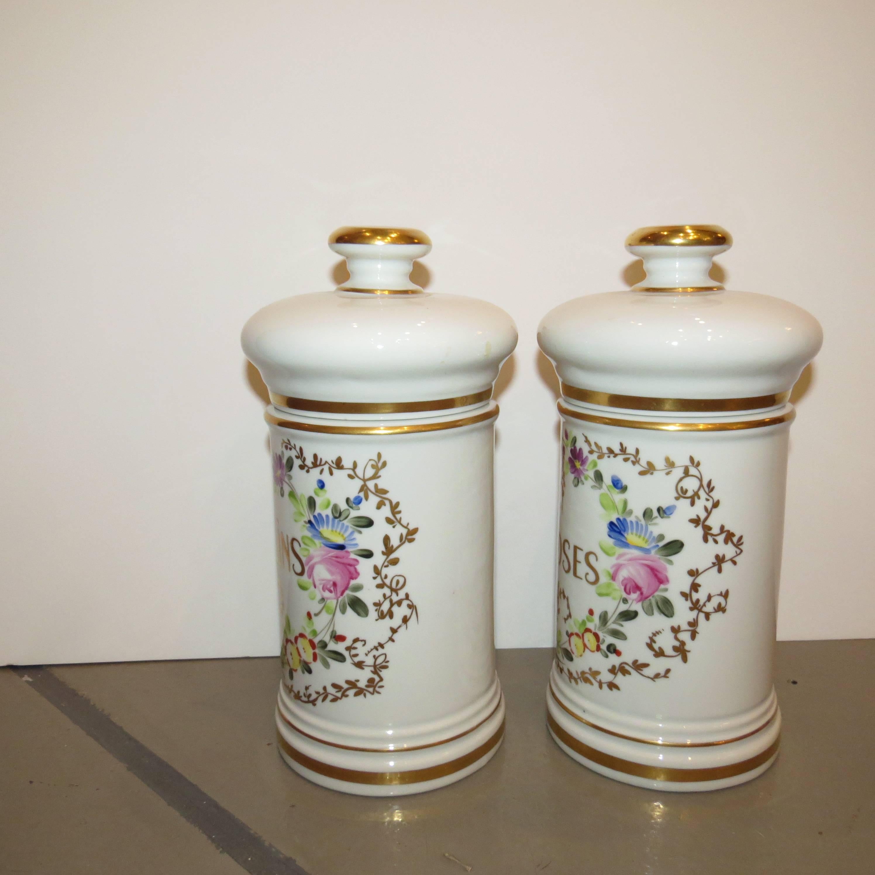 Pair of 20th century, white French porcelain lidded jars. Hand-painted with 