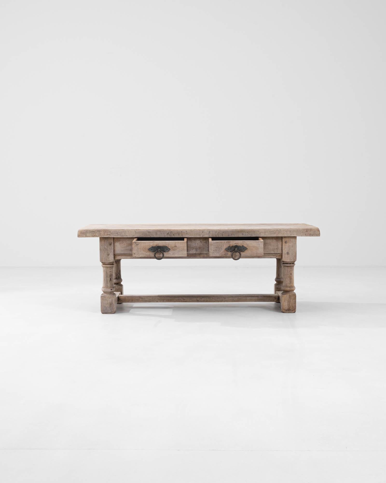 Balancing its small stature with solid proportions, this vintage coffee table in natural oak makes an attractive provincial centerpiece. Hand-built in France in the 20th century, the form imitates the sturdy silhouettes of grand country dining