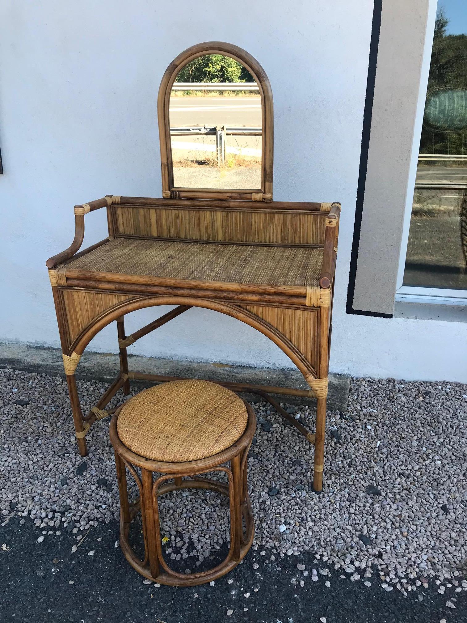 Very nice 20th century French Rattan dressing table and its stool from the 1960s. 
The mirror could be removable. Very good condition and quality.