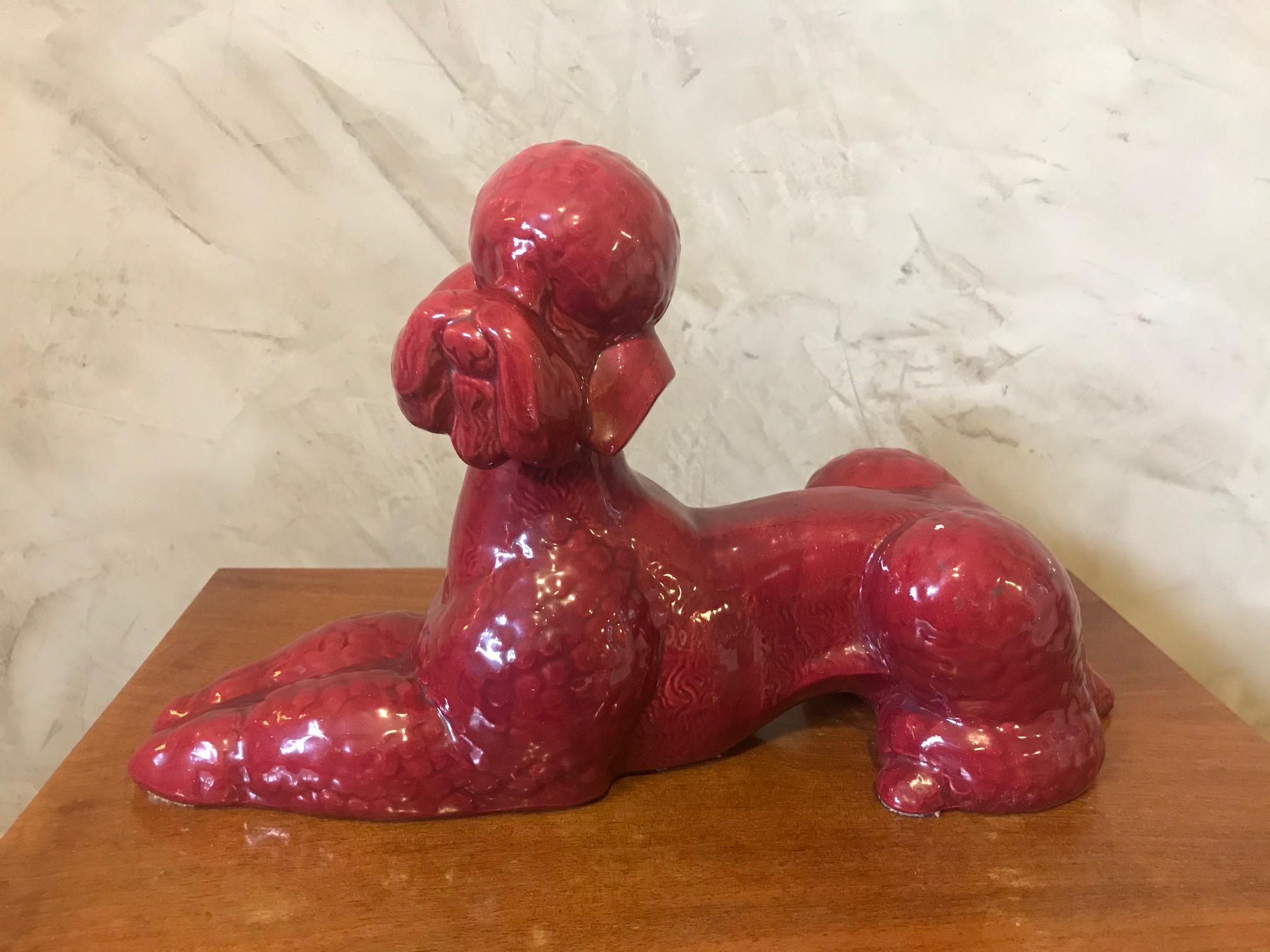 Nice 20th century French red porcelain poodle dog sculpture. 
Good quality and condition. 
France stamp at the back and a numbered.