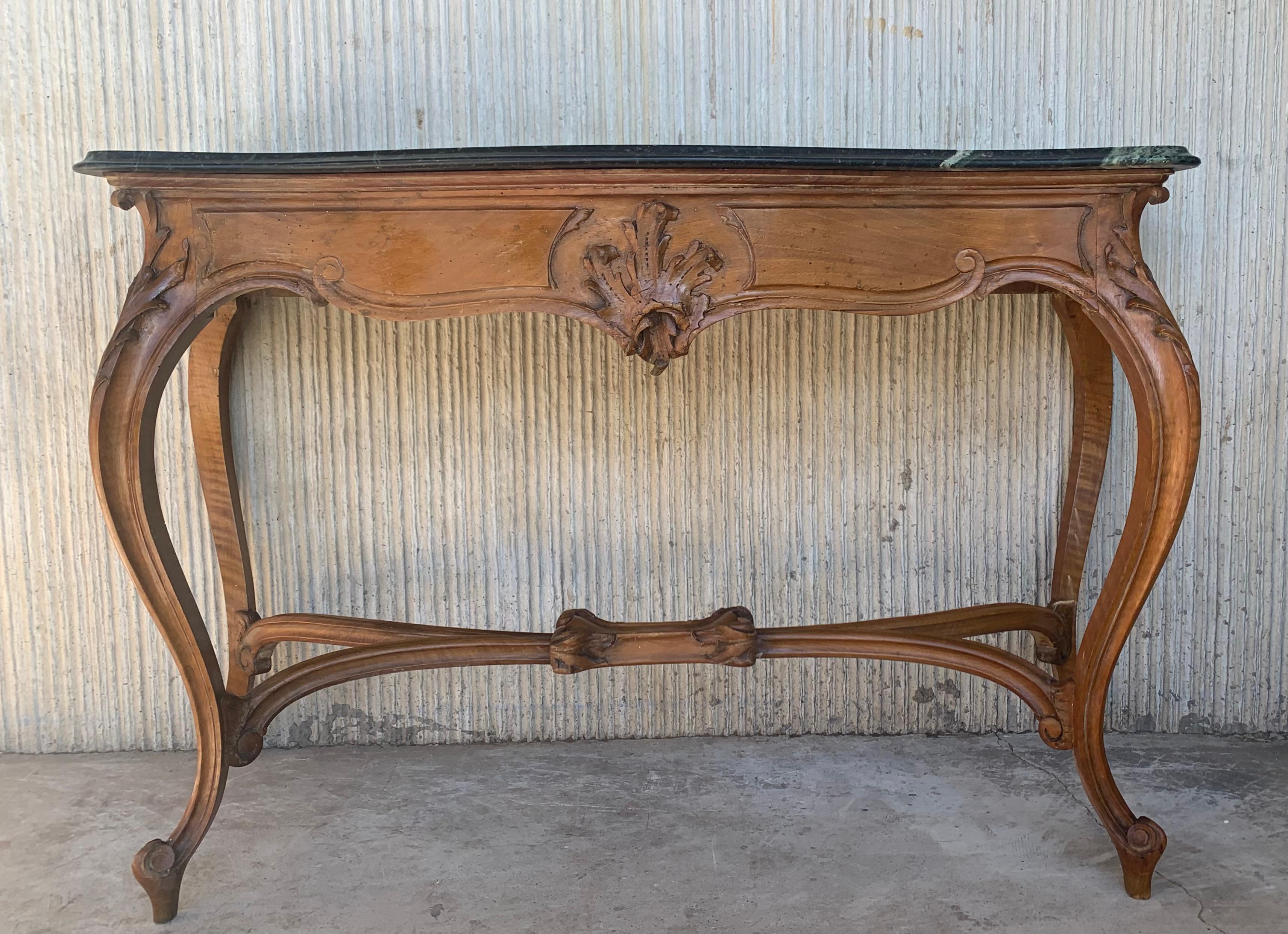 20th century French Regency carved walnut console table with marble top

20th century French Regence style beautifully carved with leaves walnut console. Marble top over hand-carved frieze supported by four cabriole legs connected by X-form
