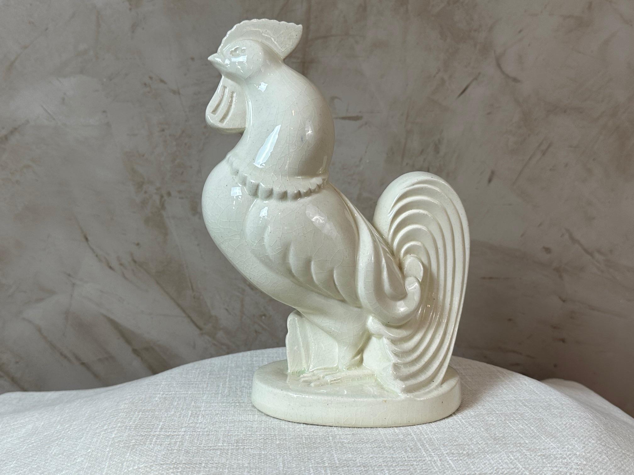 Beautiful crackled ceramic rooster from the Art Deco period in very good condition. In the style of Jacques Adnet. 
Numbered under the base. The rooster stands proud and elegantly.
For lovers of decorative objects.