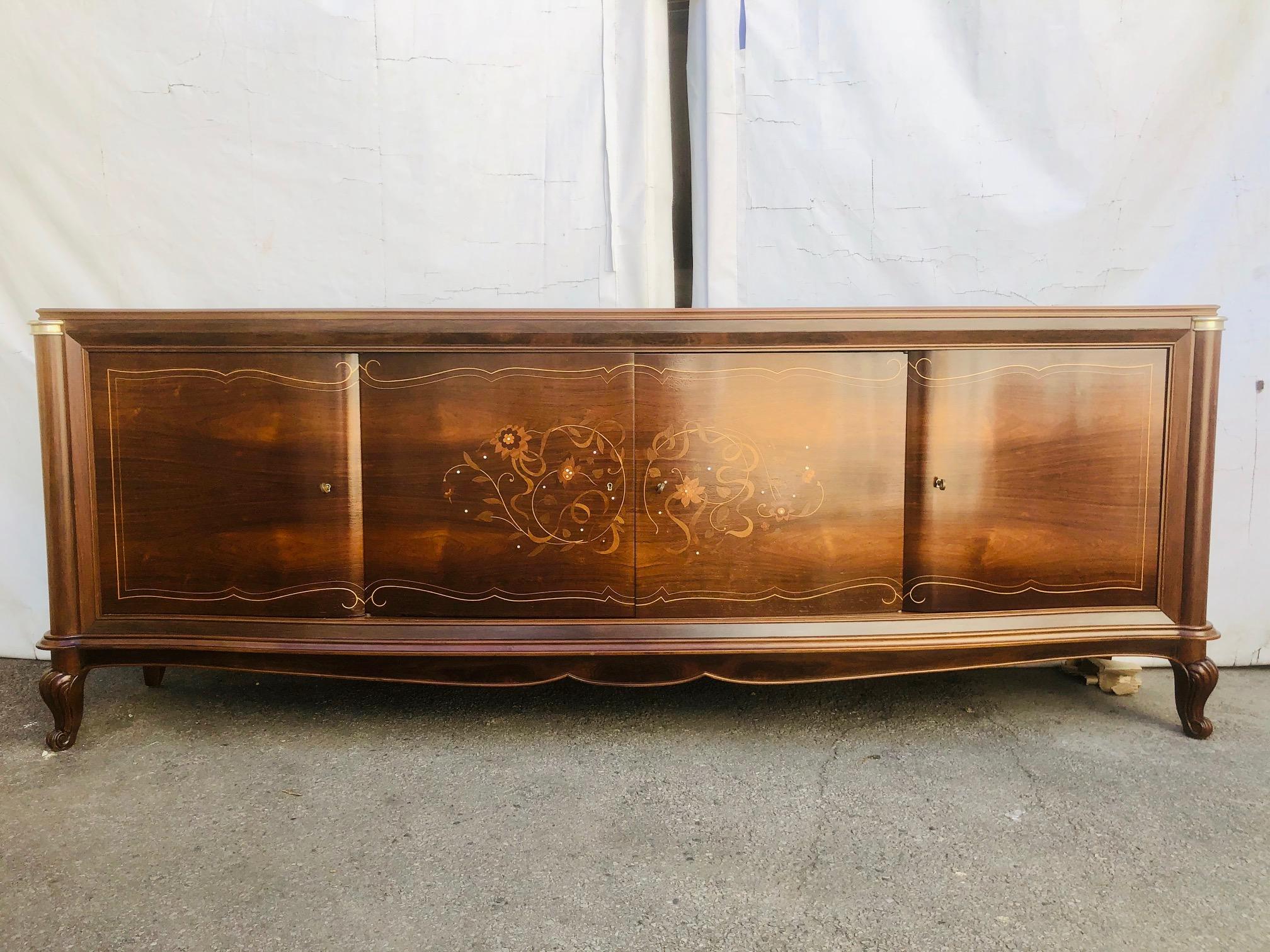 Splendid rosewood sideboard with four doors in Art Deco style, produced in the beginning of the 1930's. Research into similar products from the late 1920s and early 1930s has linked him to the work of the great art deco designer Jules Leleu. Its