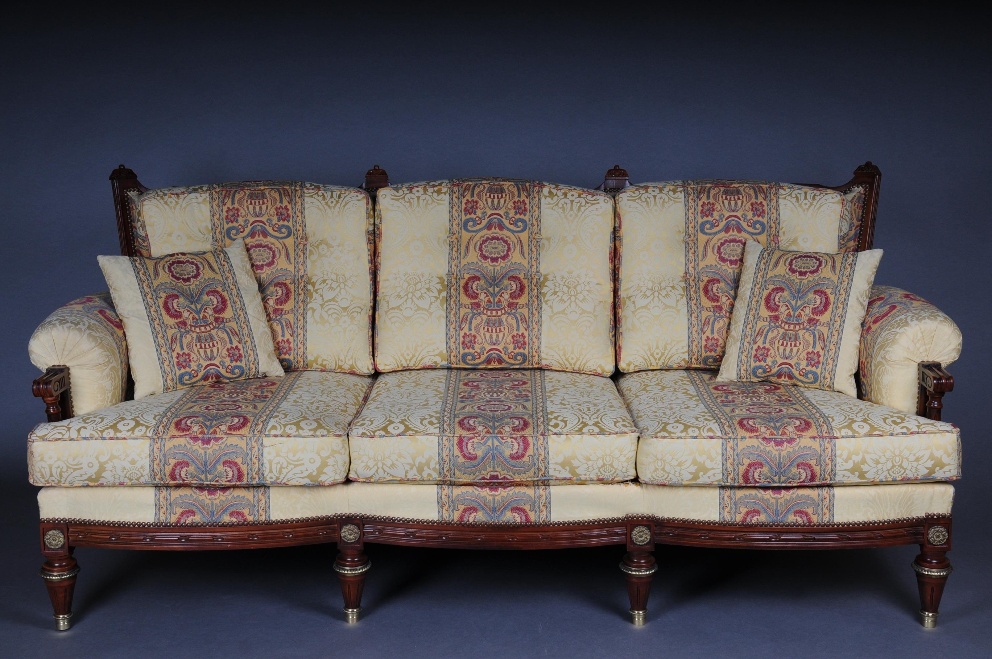 20th century French seating group / couch set Louis XVI

Solid wood, carved and painted. Slightly curved frame on fluted legs. Slanted, fluted, slightly rising armrests. High curly backrest framing. The seat and backrest are finished with