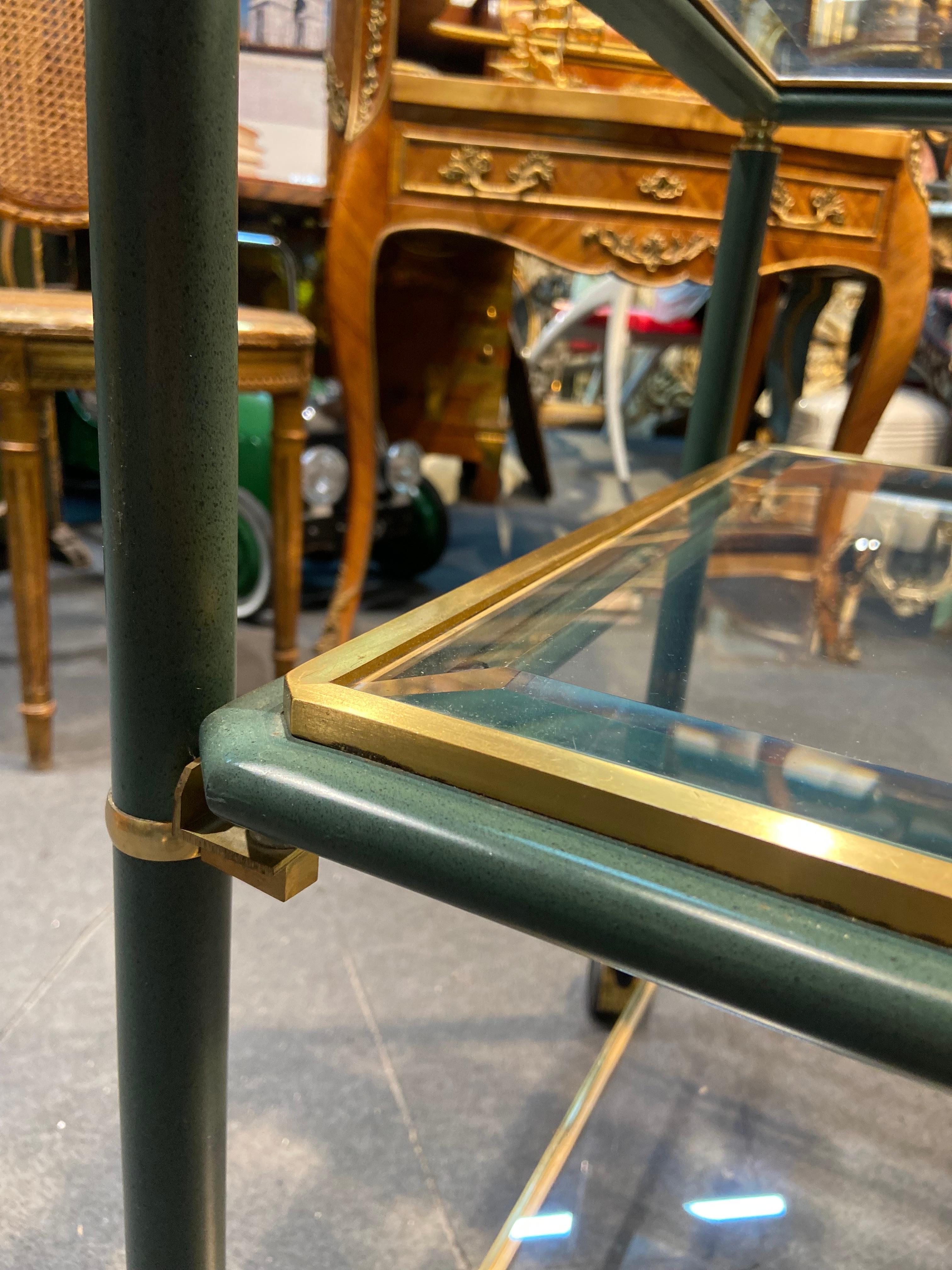French serving bar cart in brass and glass hand painted in green and gold. 
There are three levels in equal size with original glass shelves. The piece is raised on four brass castors.
France, circa 1920. 
A great elegant addition to any stylish