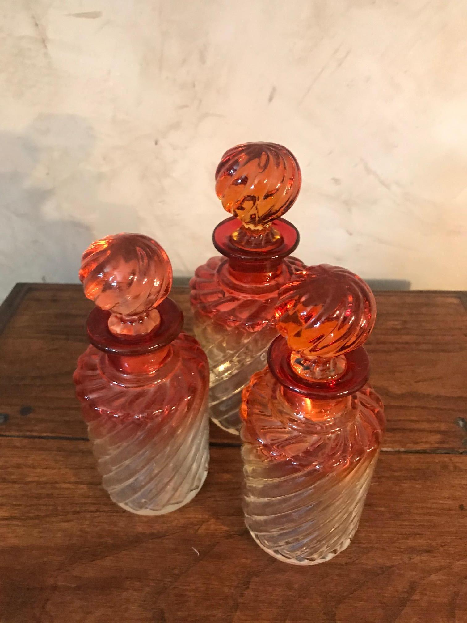 Very nice 20th century French set of three glass perfume bottle from the 1900s. 
Beautiful handgraved glass work. Originale red and transparent color. 
Separated plugs, little bit broken but when you put it on the top, you can see it. 
Nice