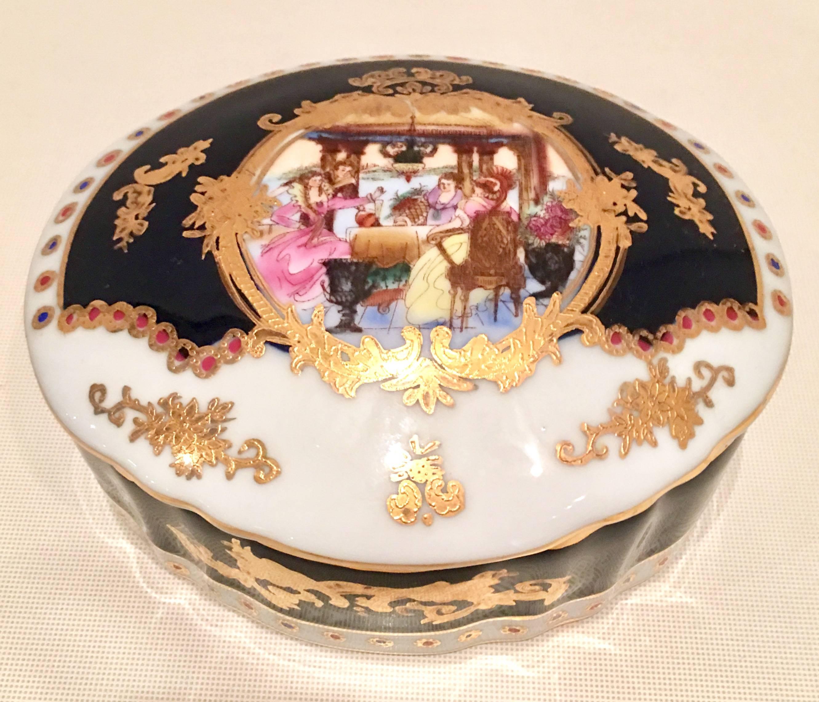 Mid-20th century French Sevres Limoges style, Porcelain hand-painted Cobalt & 22-karat gold large handled tray and lidded oval box. This three-piece set includes a large oval tray with heart motif cut-out handles and oval lidded box. Each features
